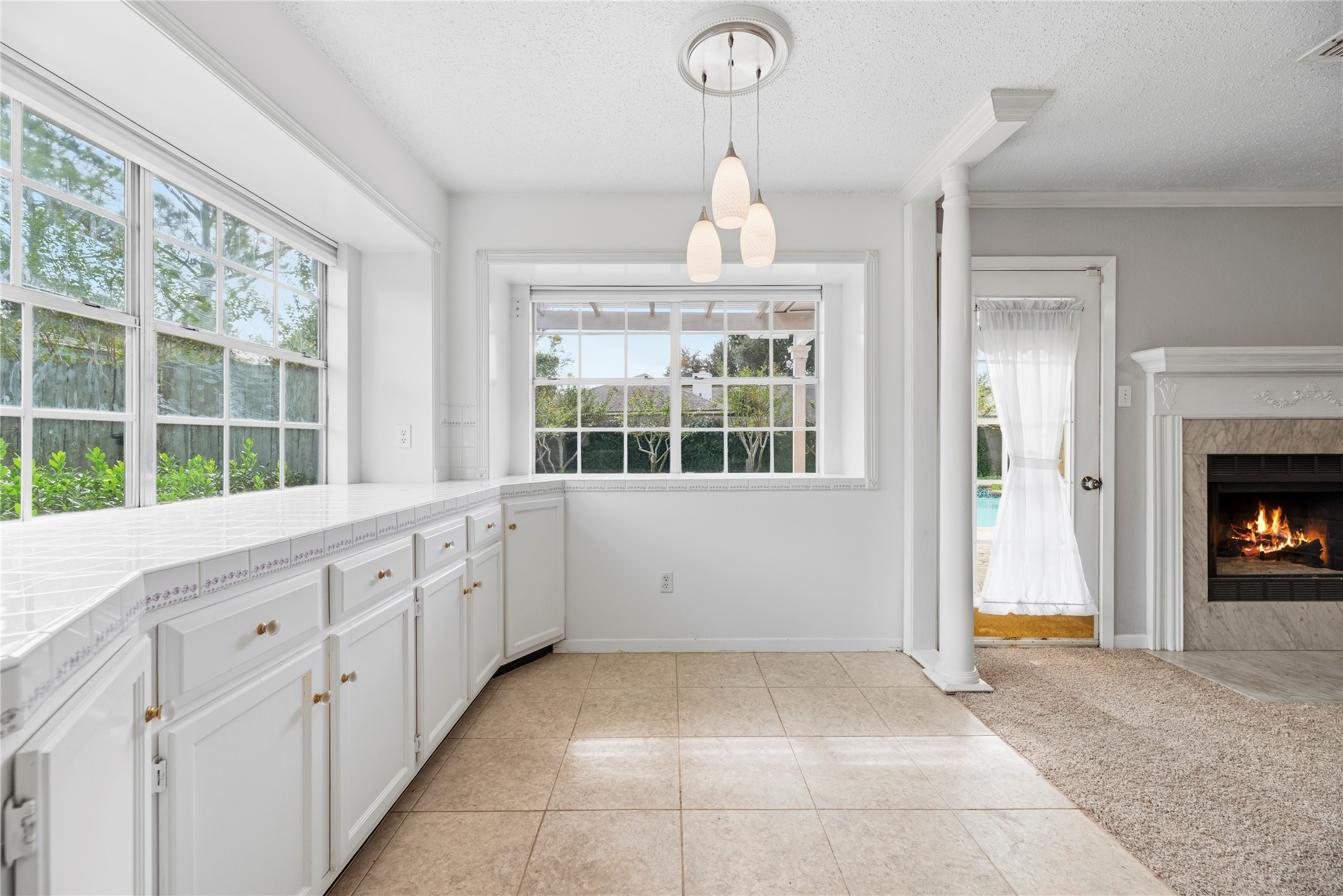 Spacious breakfast room with additional cabinetry and countertop space.