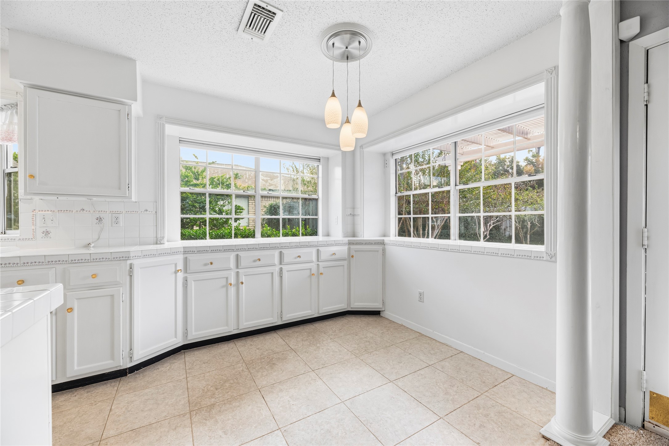 Spacious breakfast room with additional cabinetry and countertop space.