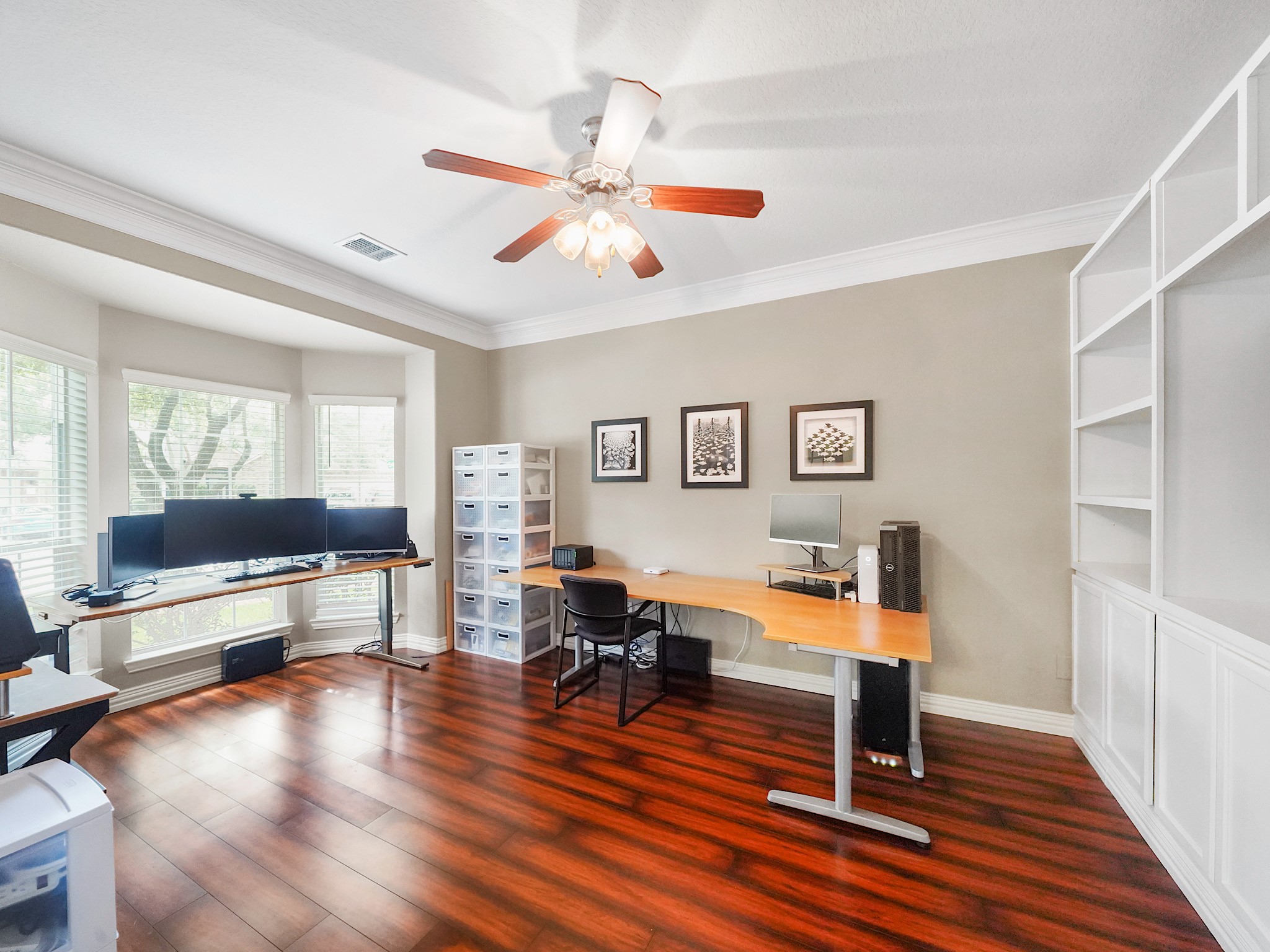Custom built-ins, rich flooring, and abundant natural light create a workspace that is as functional as it is refined.