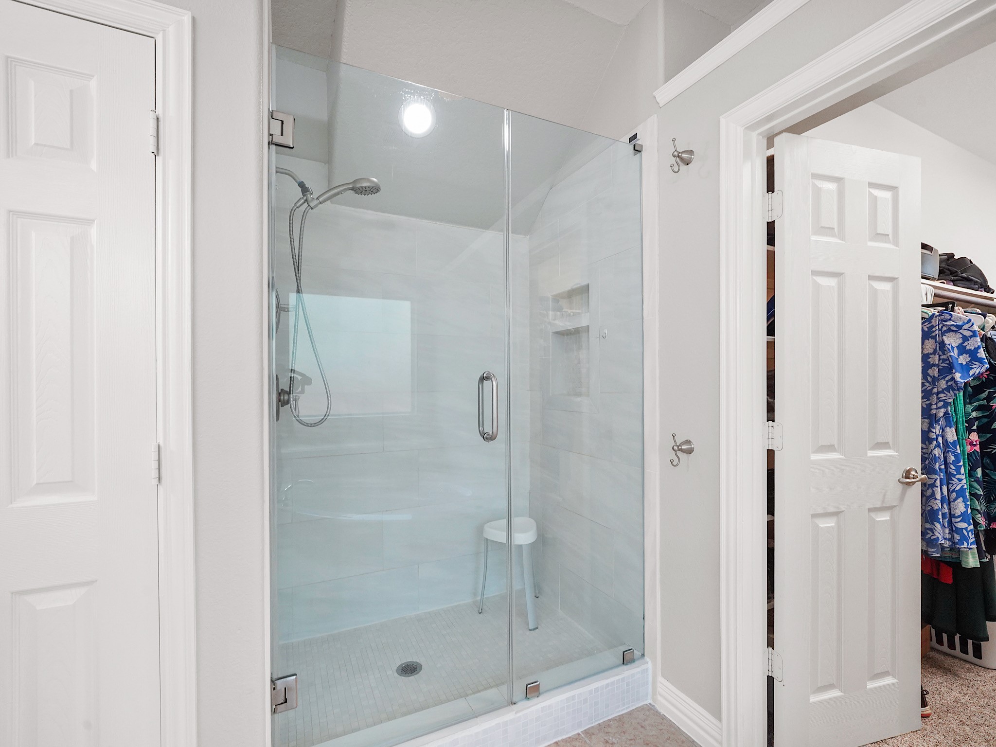 Recently updated, the frameless glass shower adds a touch of modern luxury to the primary suite.