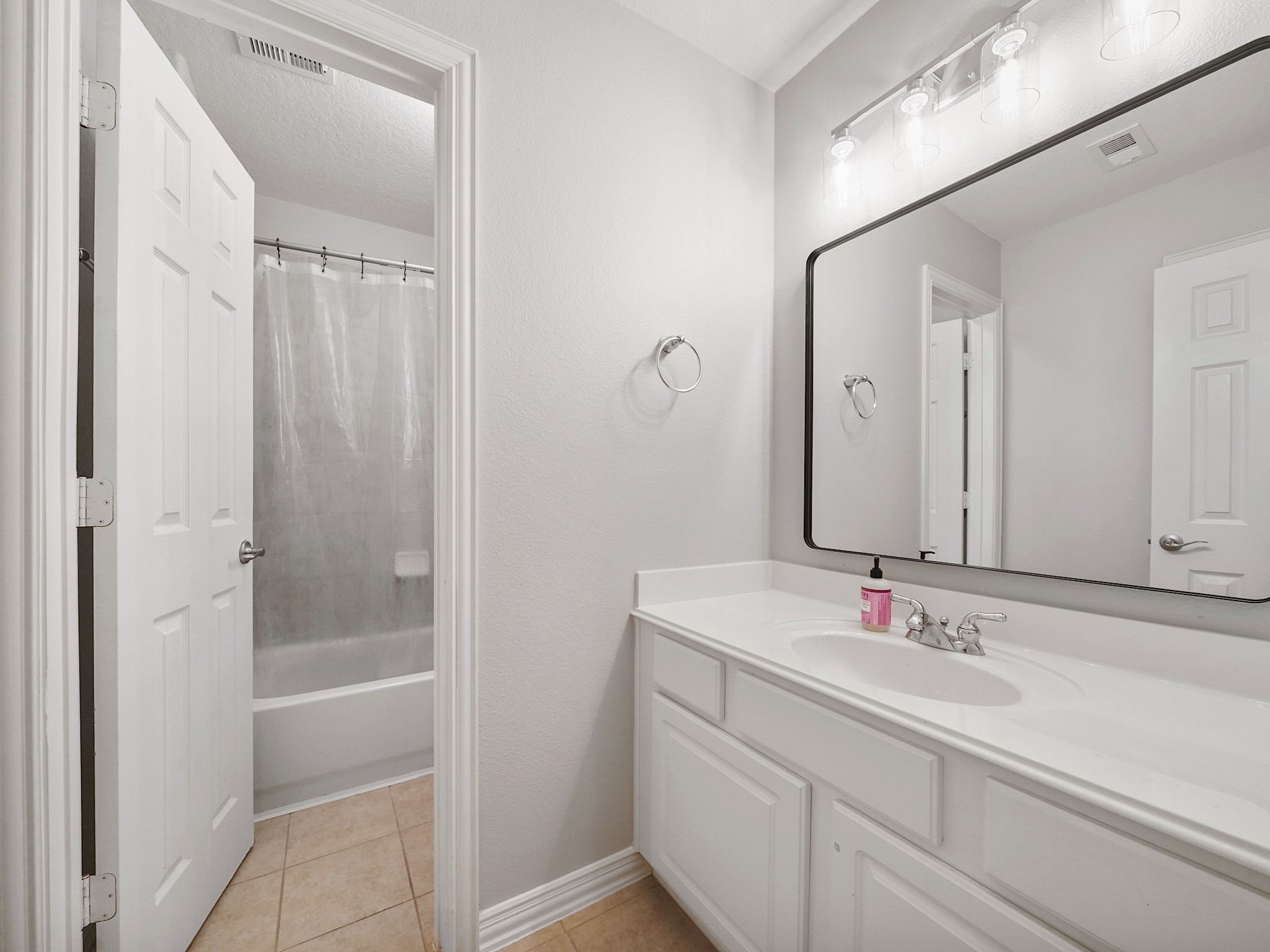 A well-appointed secondary bath offers comfort and convenience for family members and guests alike.