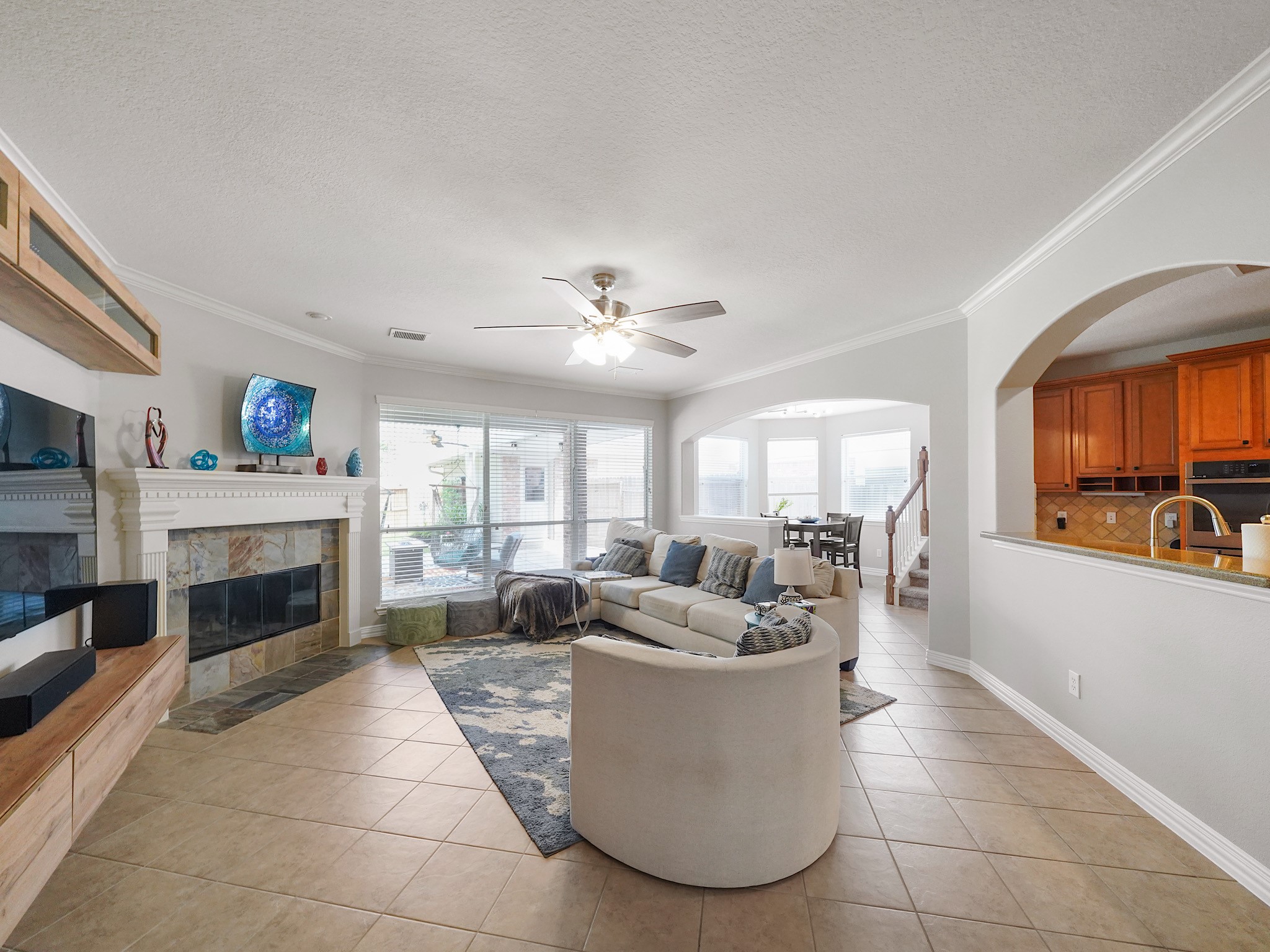 Anchored by a gas fireplace and framed by large windows, the family room offers a welcoming place to gather, relax, and connect.