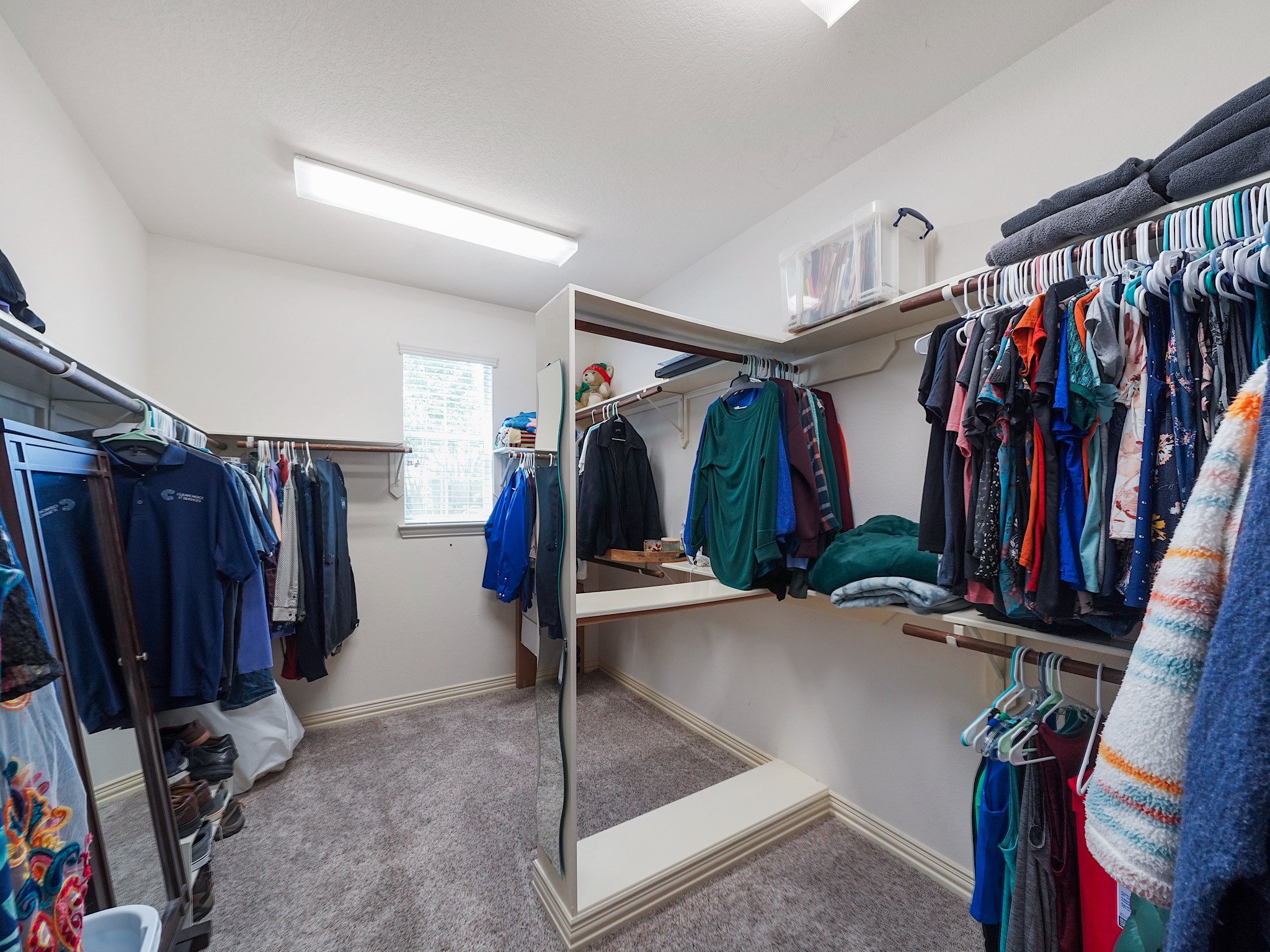 An oversized walk-in closet offers exceptional storage and organization for every season.