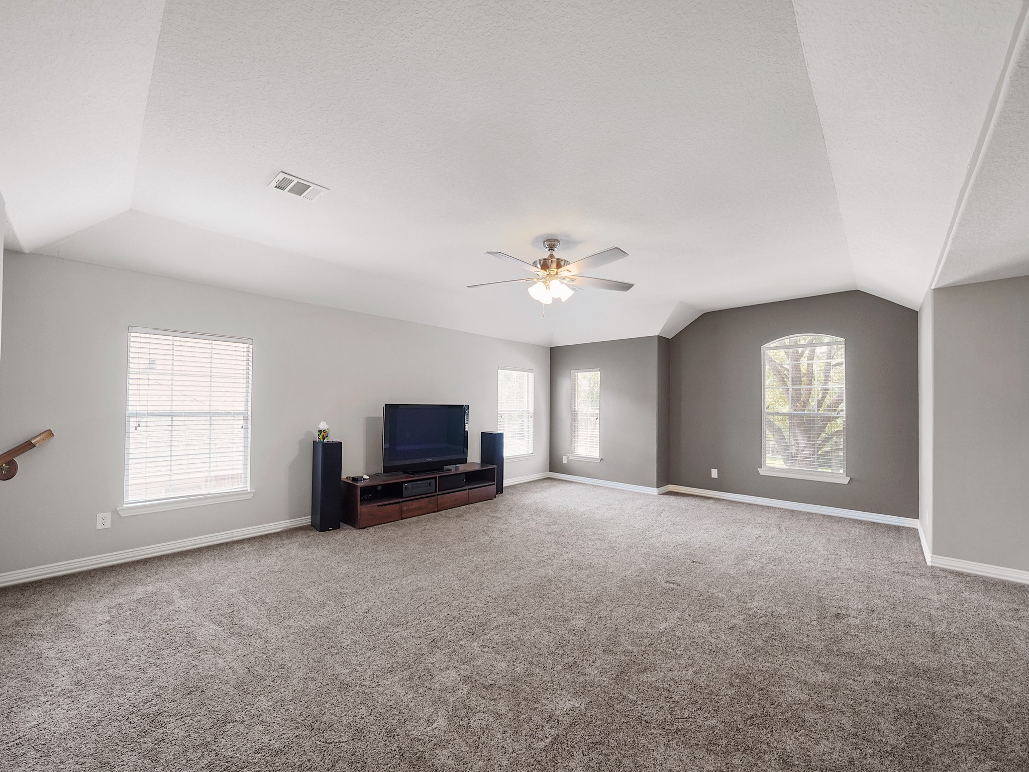 With soaring ceilings and generous dimensions, this versatile space easily accommodates multiple seating and recreation areas.