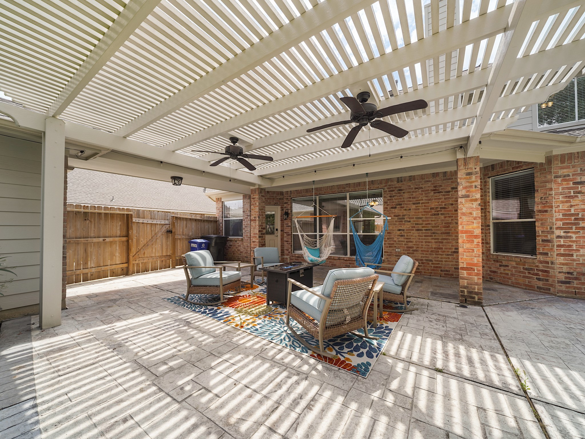 Whether hosting weekend gatherings or enjoying a quiet evening outdoors, this expansive covered patio was designed for relaxation and connection.