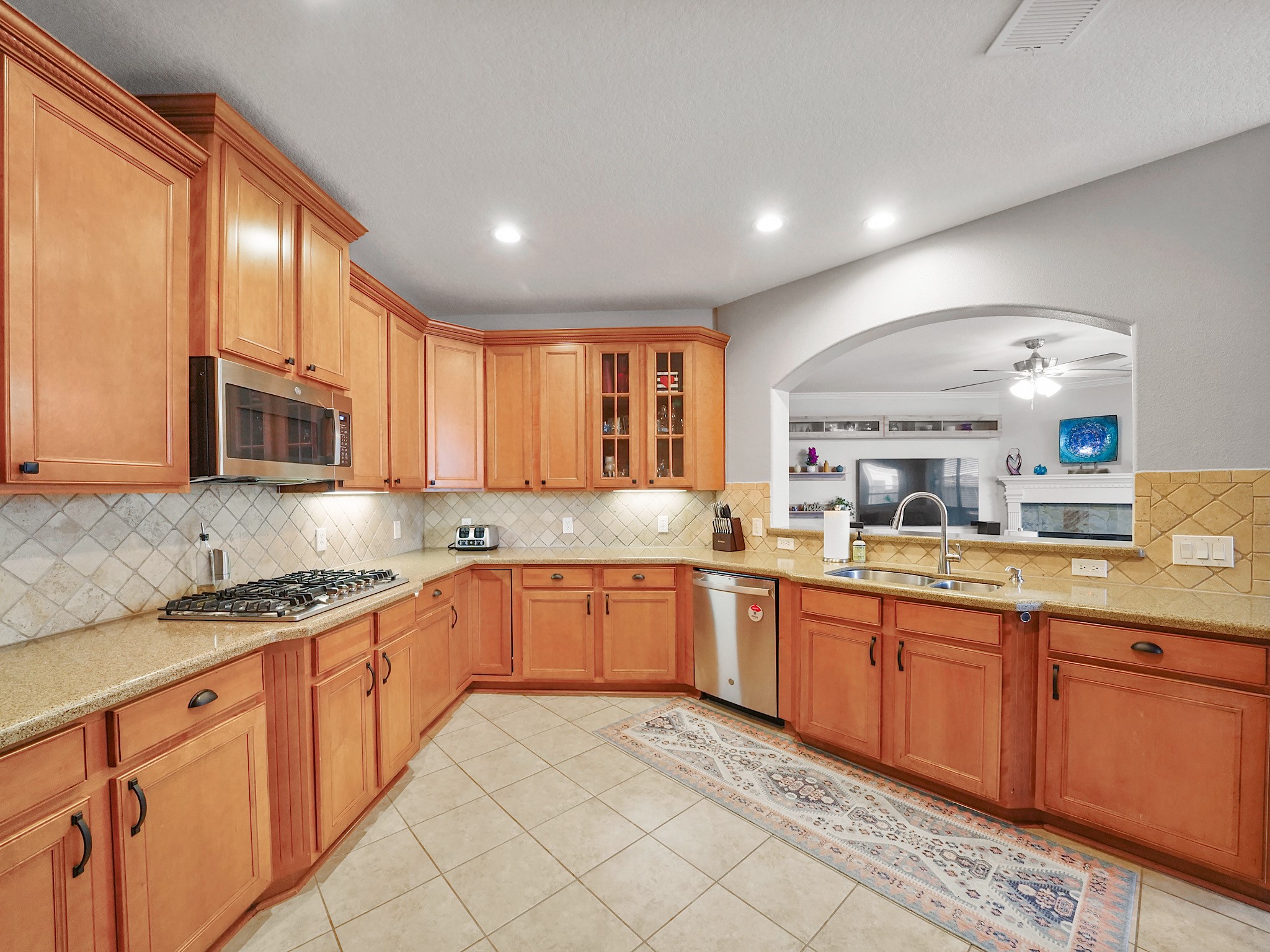 Thoughtfully designed for the home chef, the kitchen features granite countertops, double ovens, a gas cooktop, under-cabinet lighting, abundant cabinetry, and exceptional workspace.