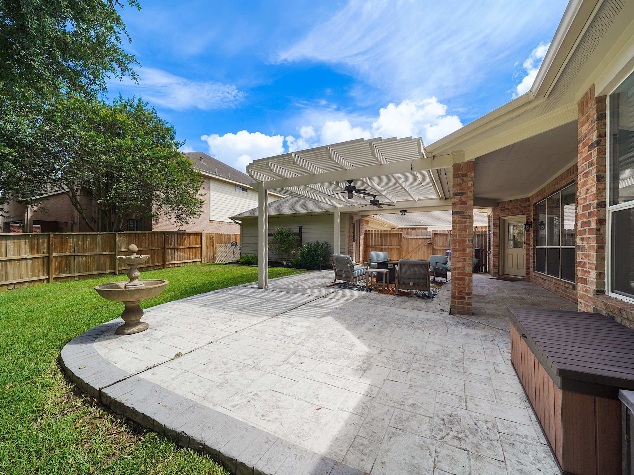 The extended patio creates a seamless transition between indoor and outdoor living, offering plenty of room for dining, entertaining, and everyday enjoyment.