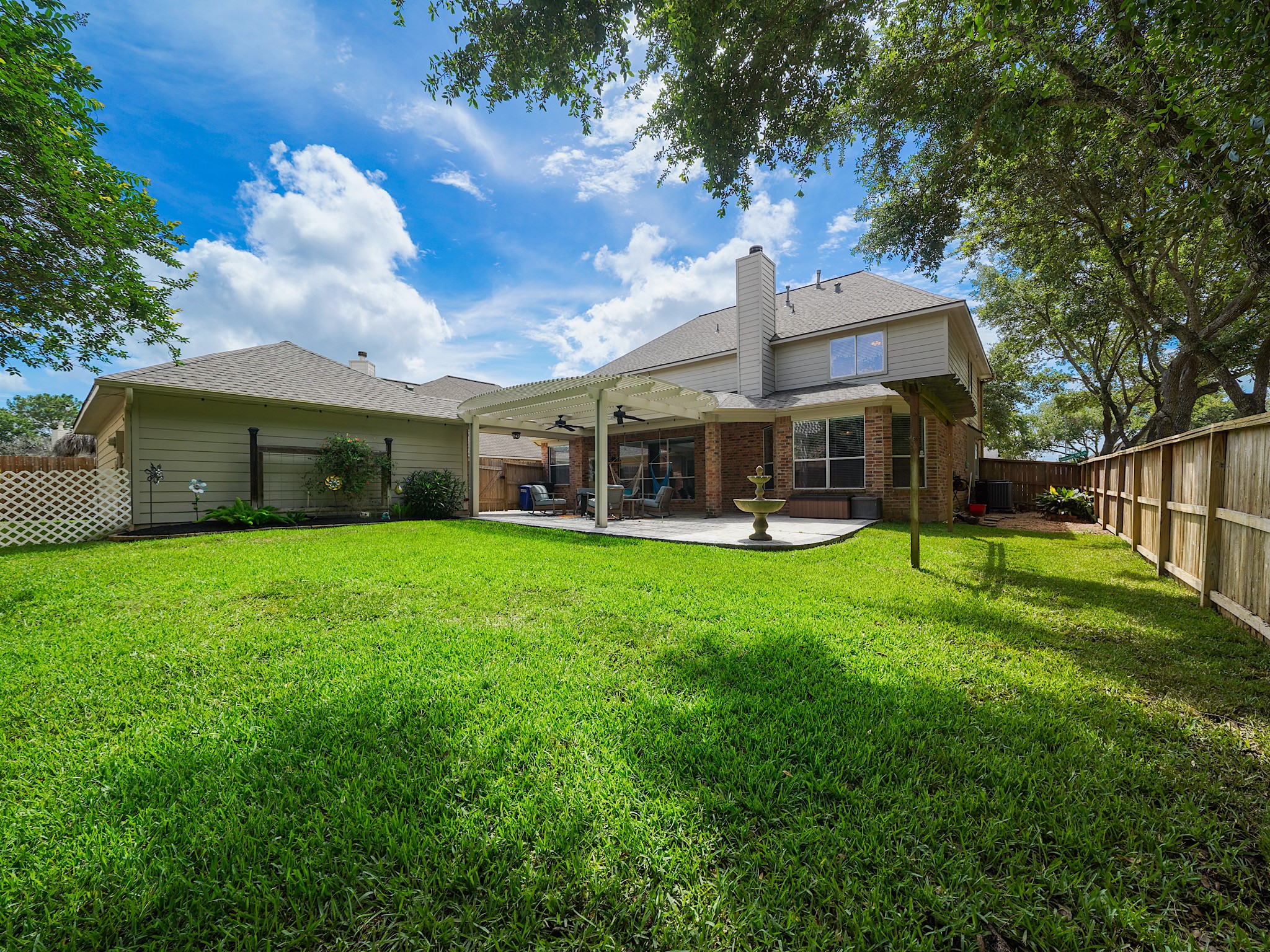 Recently refreshed landscaping enhances this spacious backyard, creating a serene setting with room to play, garden, or simply unwind.