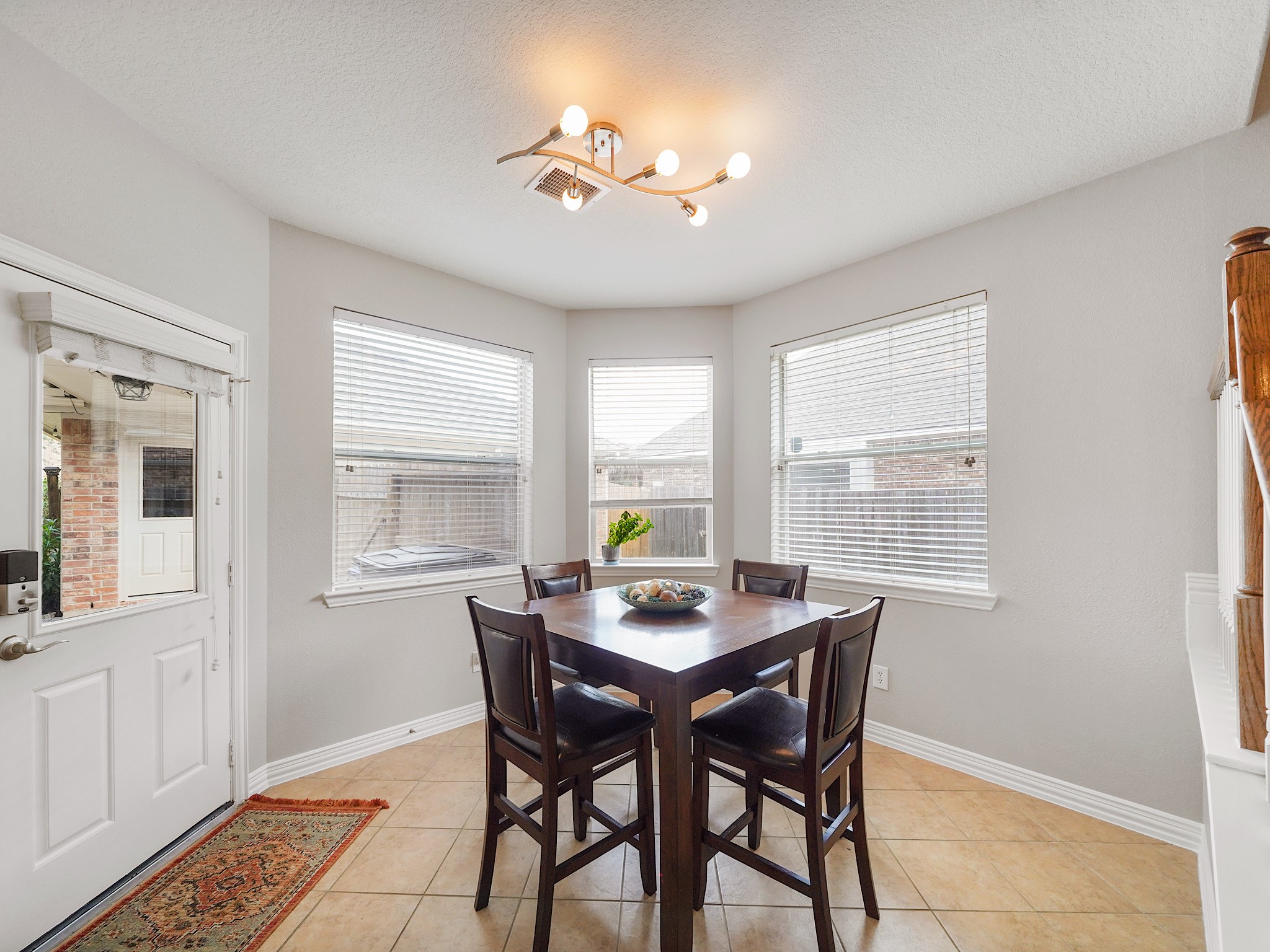 Surrounded by windows and backyard views, the breakfast room provides a bright and cheerful setting to start each day.