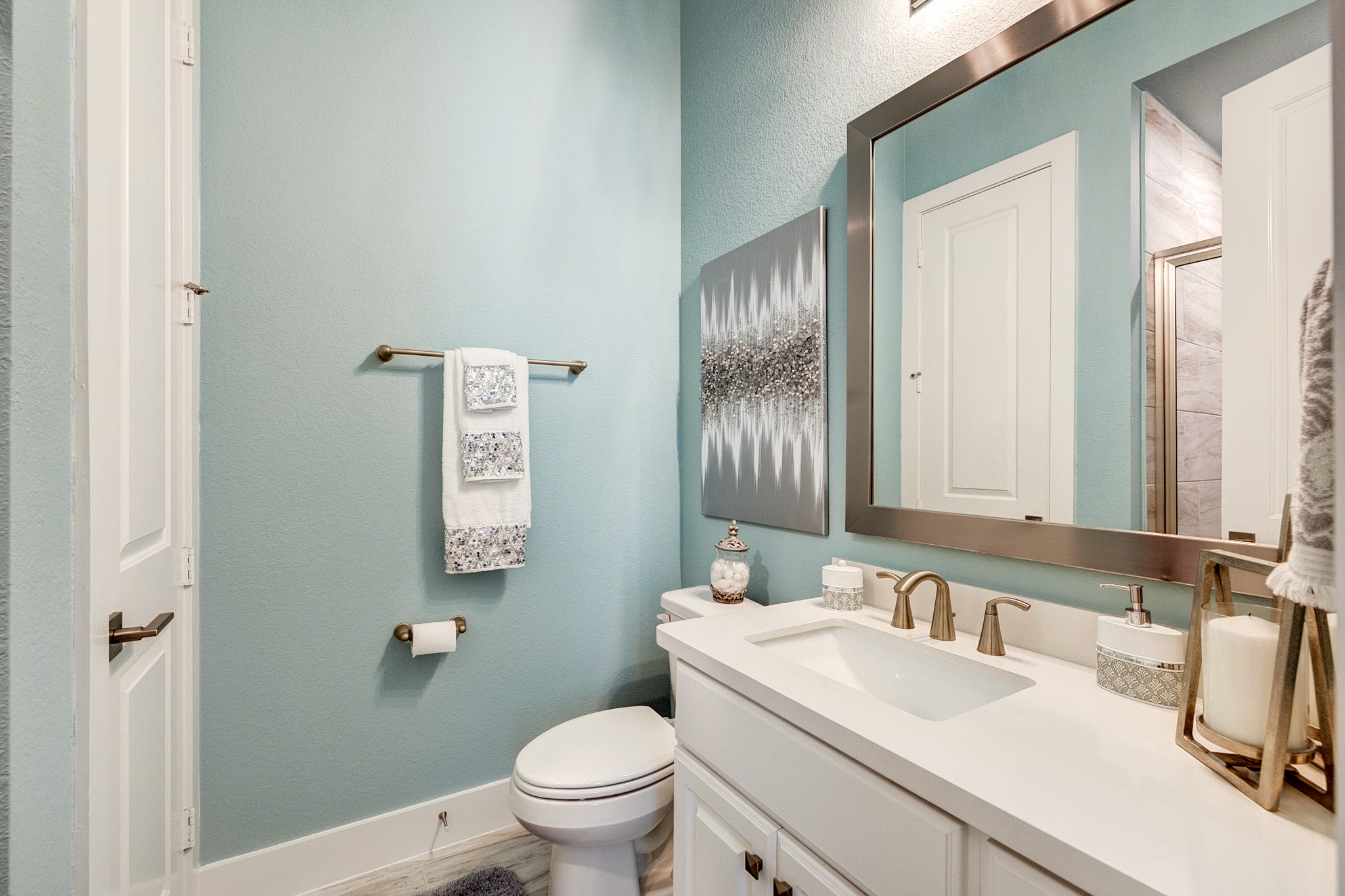 Upgraded floor-to-ceiling tile, hardware and custom mirror framing.