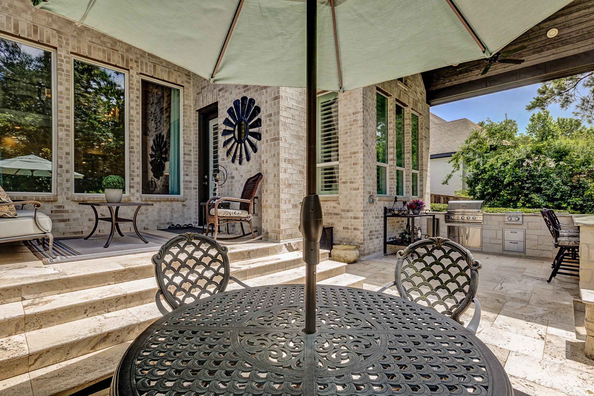 Step down from the covered back patio to the bar at the outdoor kitchen