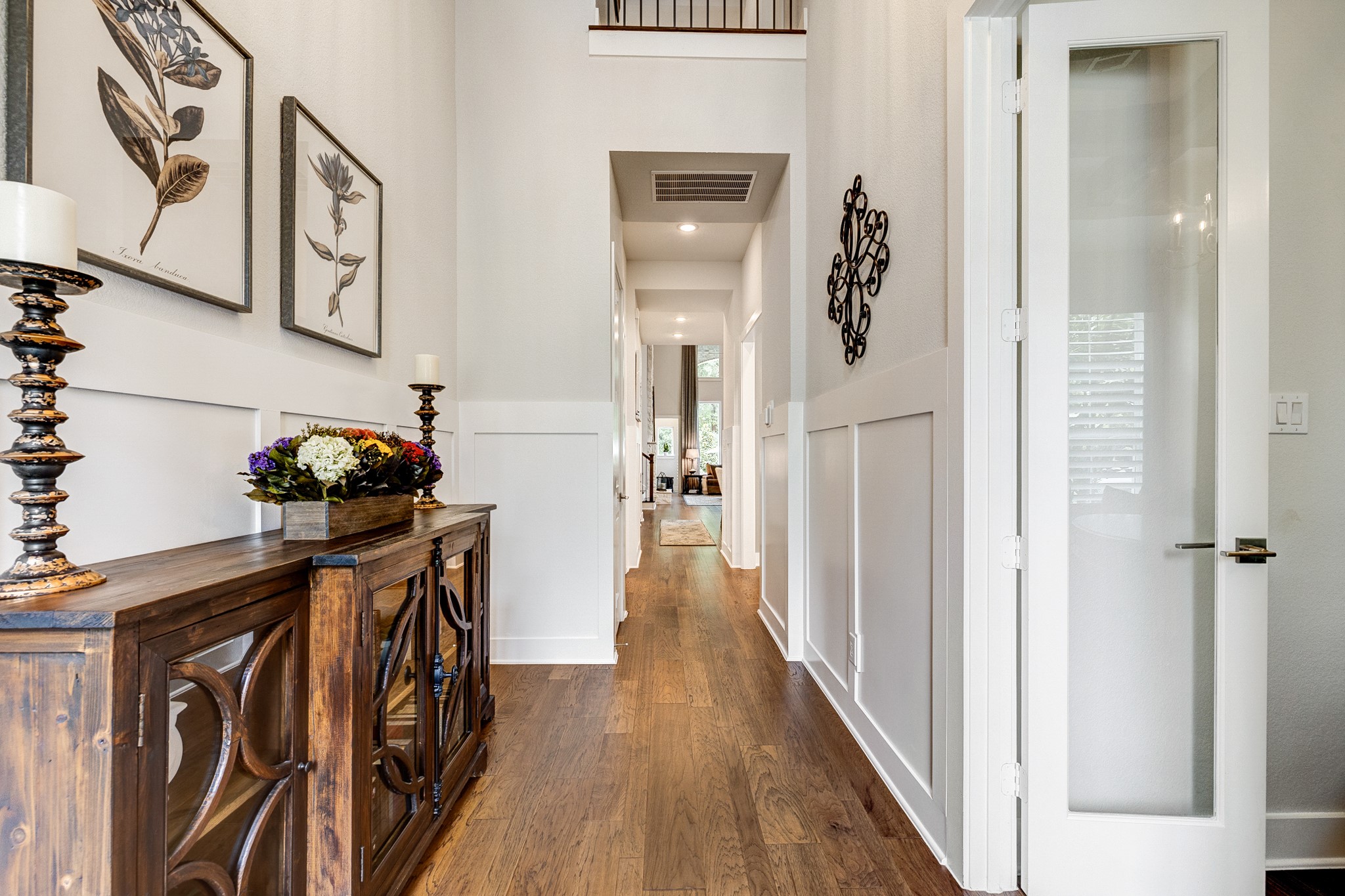 Stunning two-story entryway featuring elegant upgraded wainscoting and architectural detailing. Stunning two-story entryway featuring elegant upgraded wainscoting and architectural detailing.