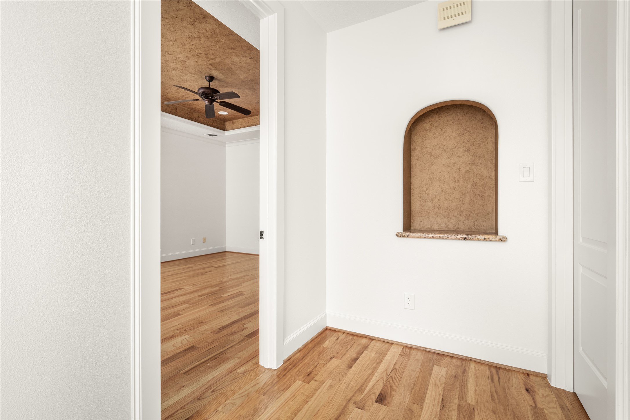 Third-floor hallway leading to the primary suite.