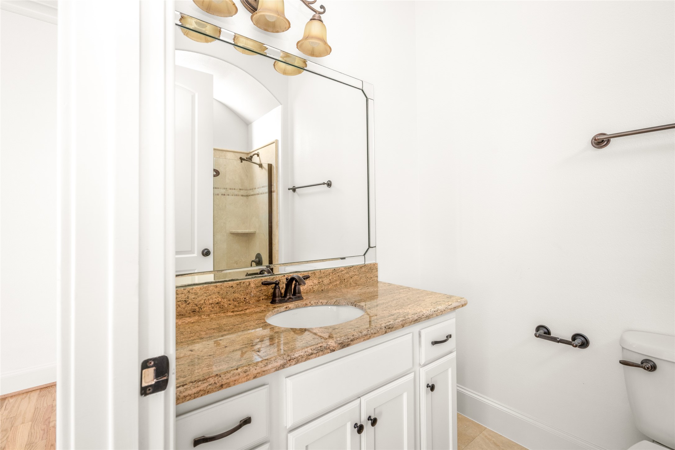 First-floor bathroom with granite countertops.
