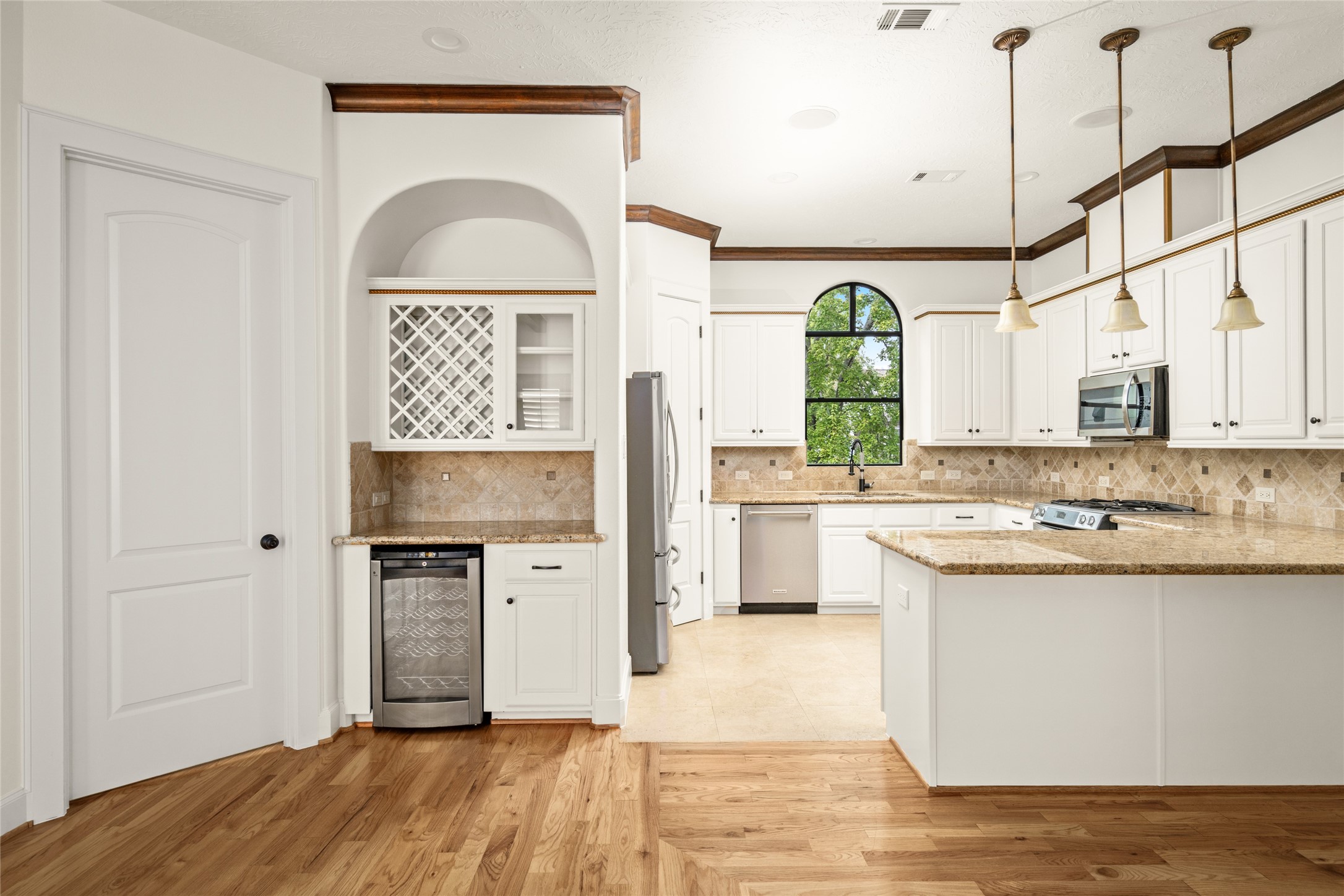 View of the built-in wine bar and kitchen from the living room.
