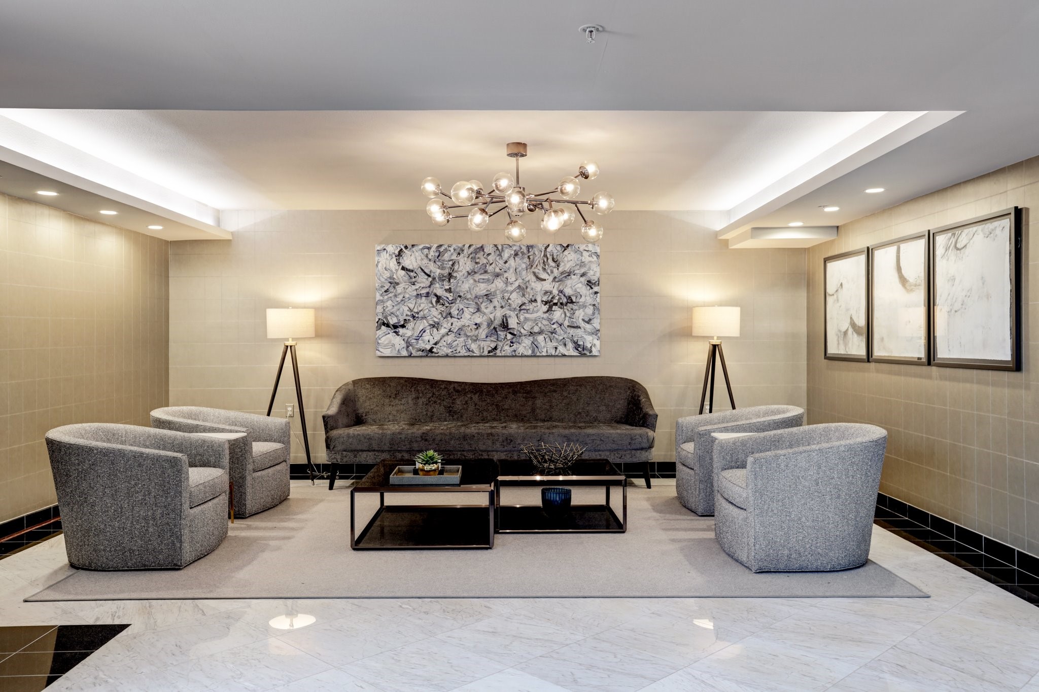 The Renoir's thoughtfully designed resident lounge features elegant furnishings, architectural detailing, and a sophisticated atmosphere. This inviting common area reflects the building's European-inspired design and boutique residential character.