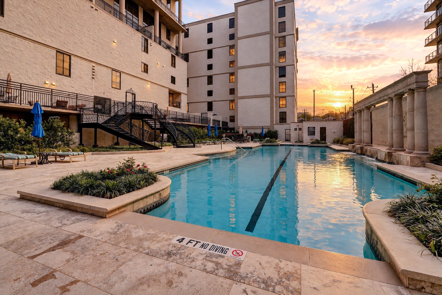 The Renoir features a private community swimming pool surrounded by landscaped grounds and an inviting poolside terrace. Residents enjoy this amenity as part of the building's shared residential offerings.
