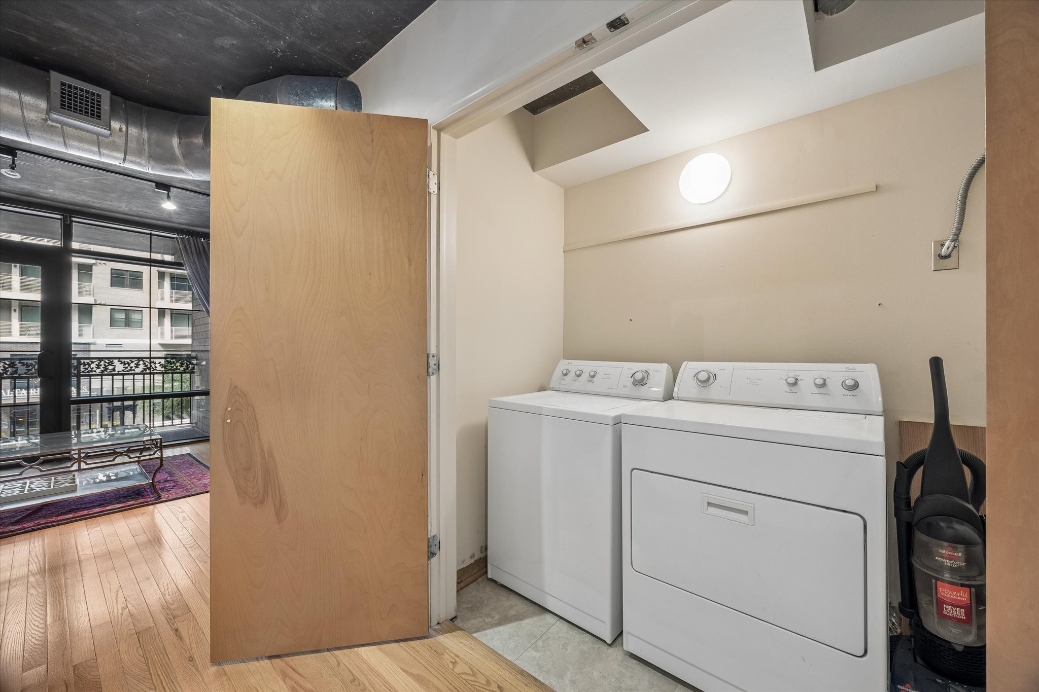 A dedicated laundry area includes a full-size washer and dryer conveniently located within the residence. Additional space provides practical functionality while keeping laundry separate from the main living areas.