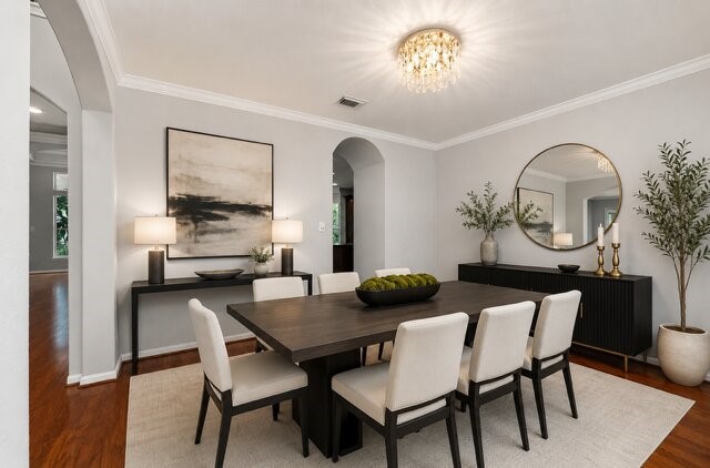 Virtually staged spacious dining room with beautiful woo floors with access to kitchen.