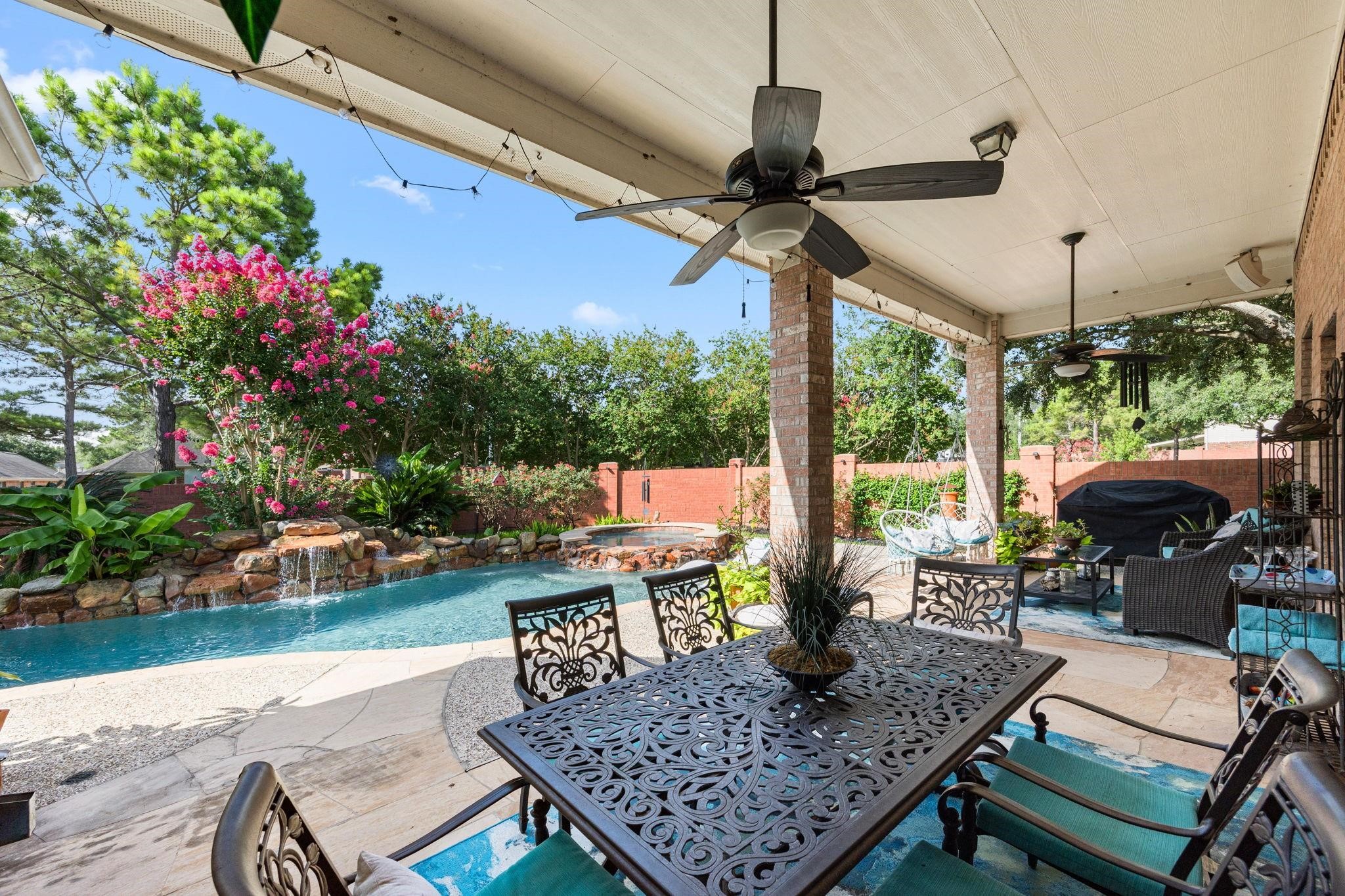 Welcome to your private retreat. This inviting salt water heated pool/spa with 7 rock waterfalls, flagstone patio & decking surrounded by lush flowering landscaping with surround sound and HOA brick privacy fence is a must see.
BARBEQUE PIT AND AQUA DOUBLE COVERED LOUNGER (stays with home).