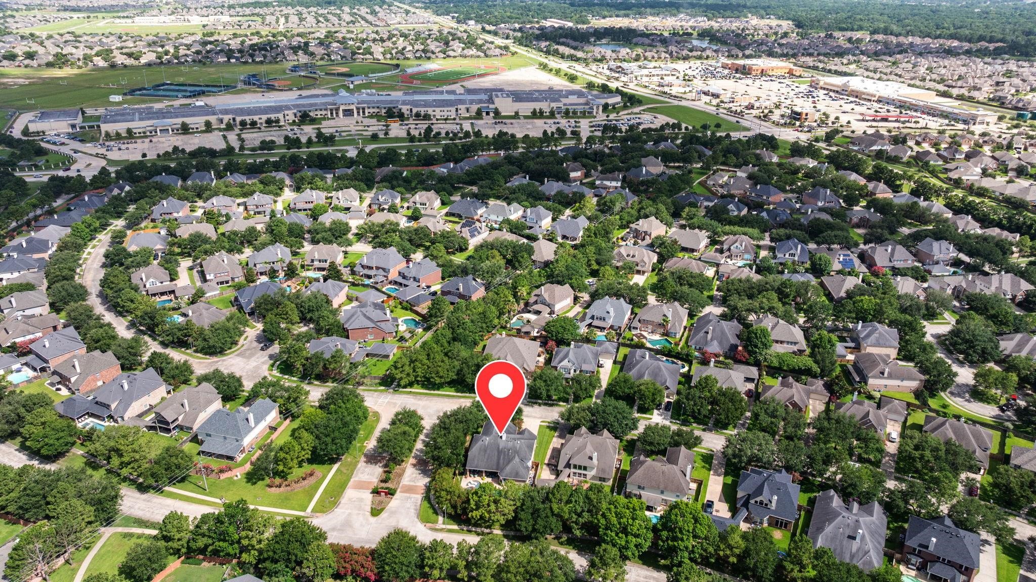 Arial view of Cinco Ranch West upscaled neighborhood with tree-lined streets, High School within walking distance and Location of 4402 Eden Point Lane.