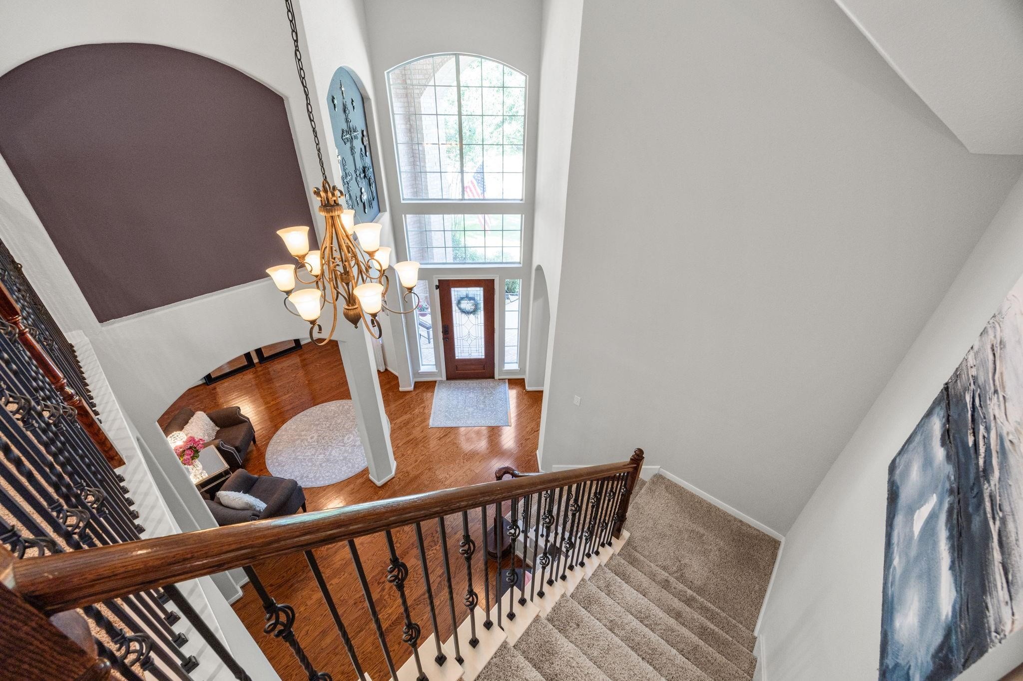 This a view looking from upstairs down to foyer. Lots of architectural picture insets done by this builder. Lots of natural light with all the windows.