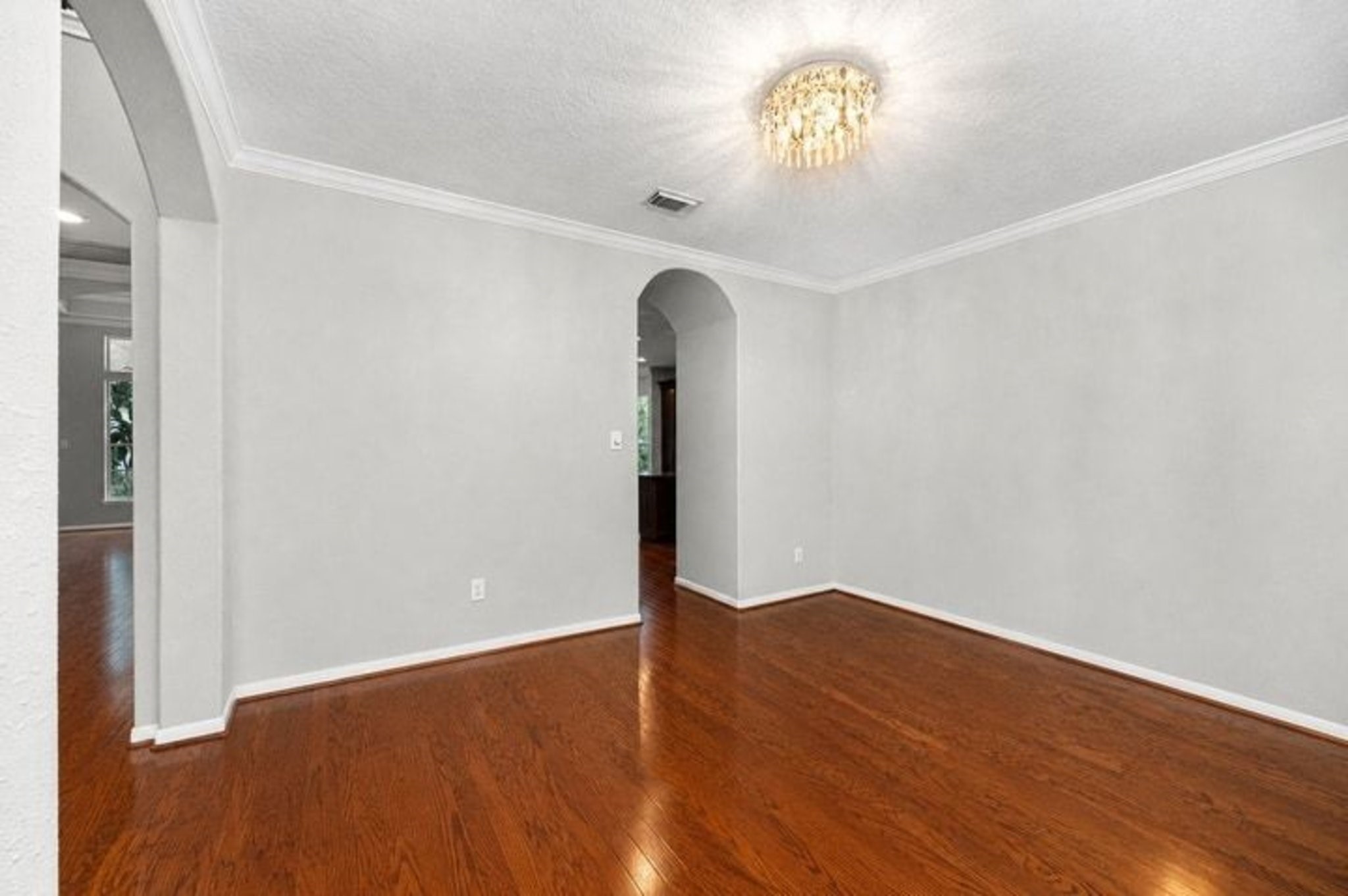 Spacious Dining Room with beautiful wood floors with access to kitchen