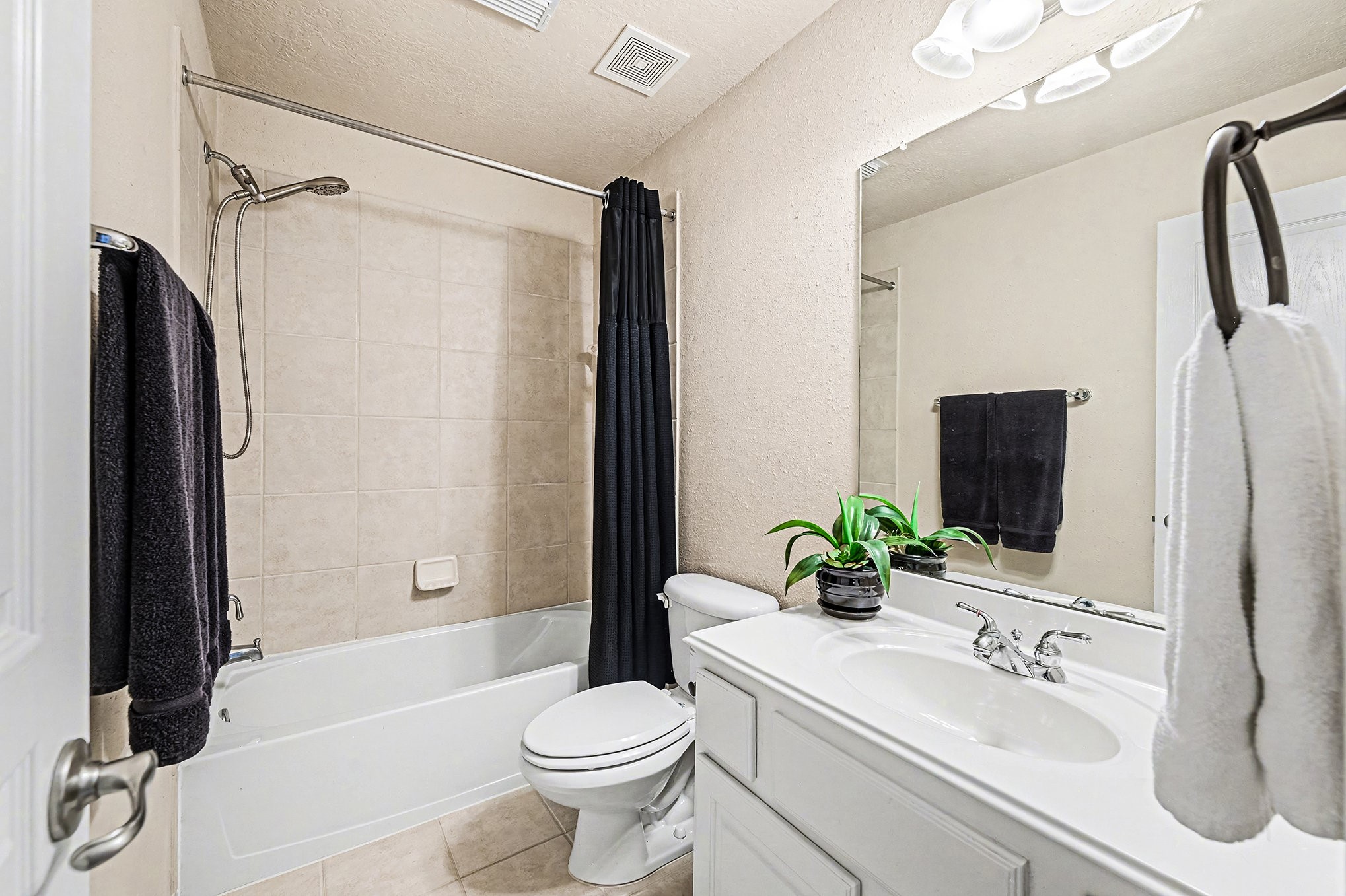 This is another bathroom upstairs which has very nuetral colors with vanity and sink.