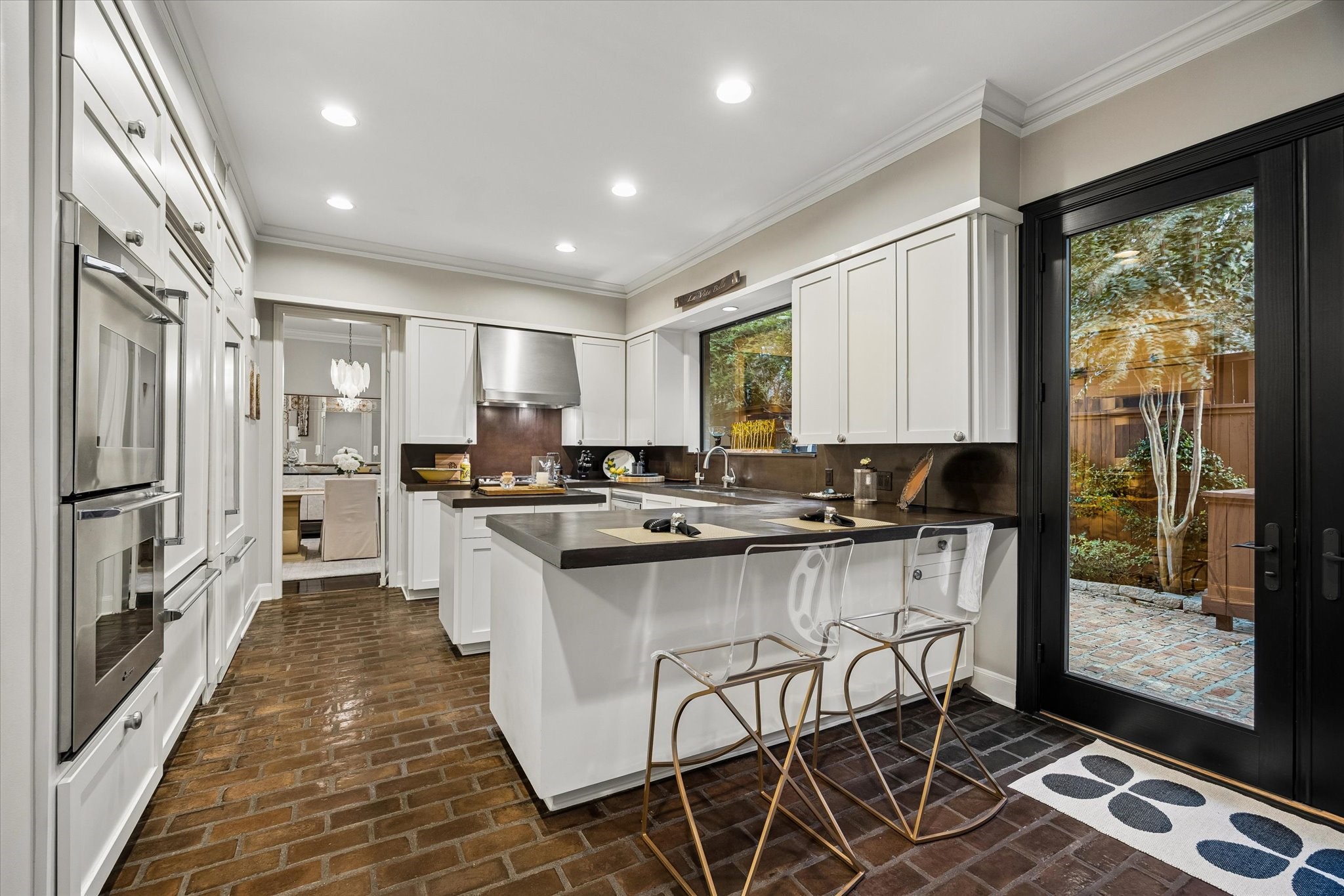 The abundance of windows and French doors bring the outdoors inside.