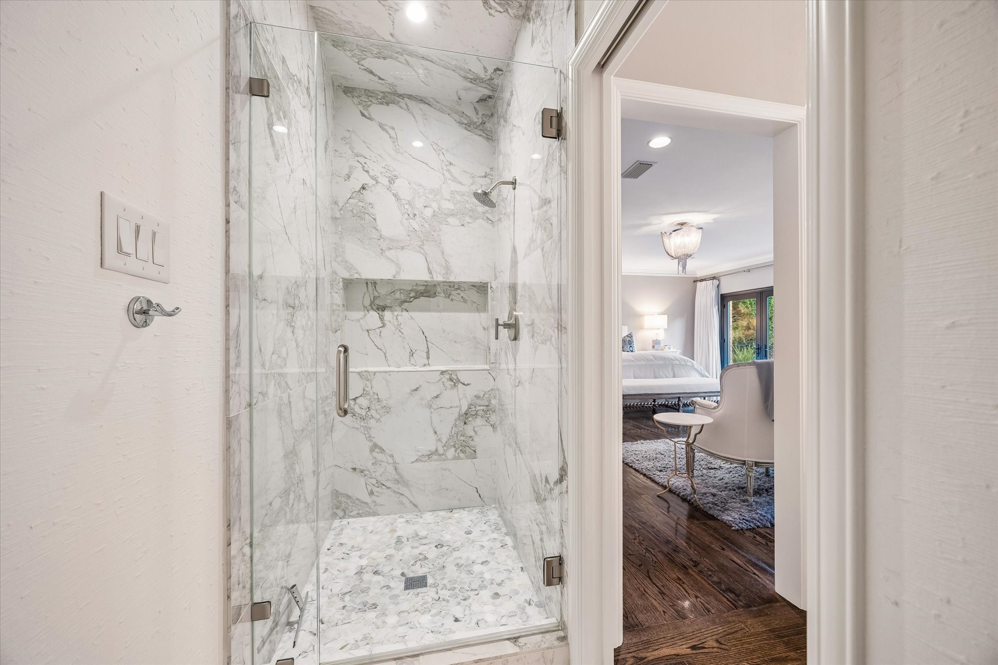 ...and the other, a marble clad Shower with a generous product shelf.