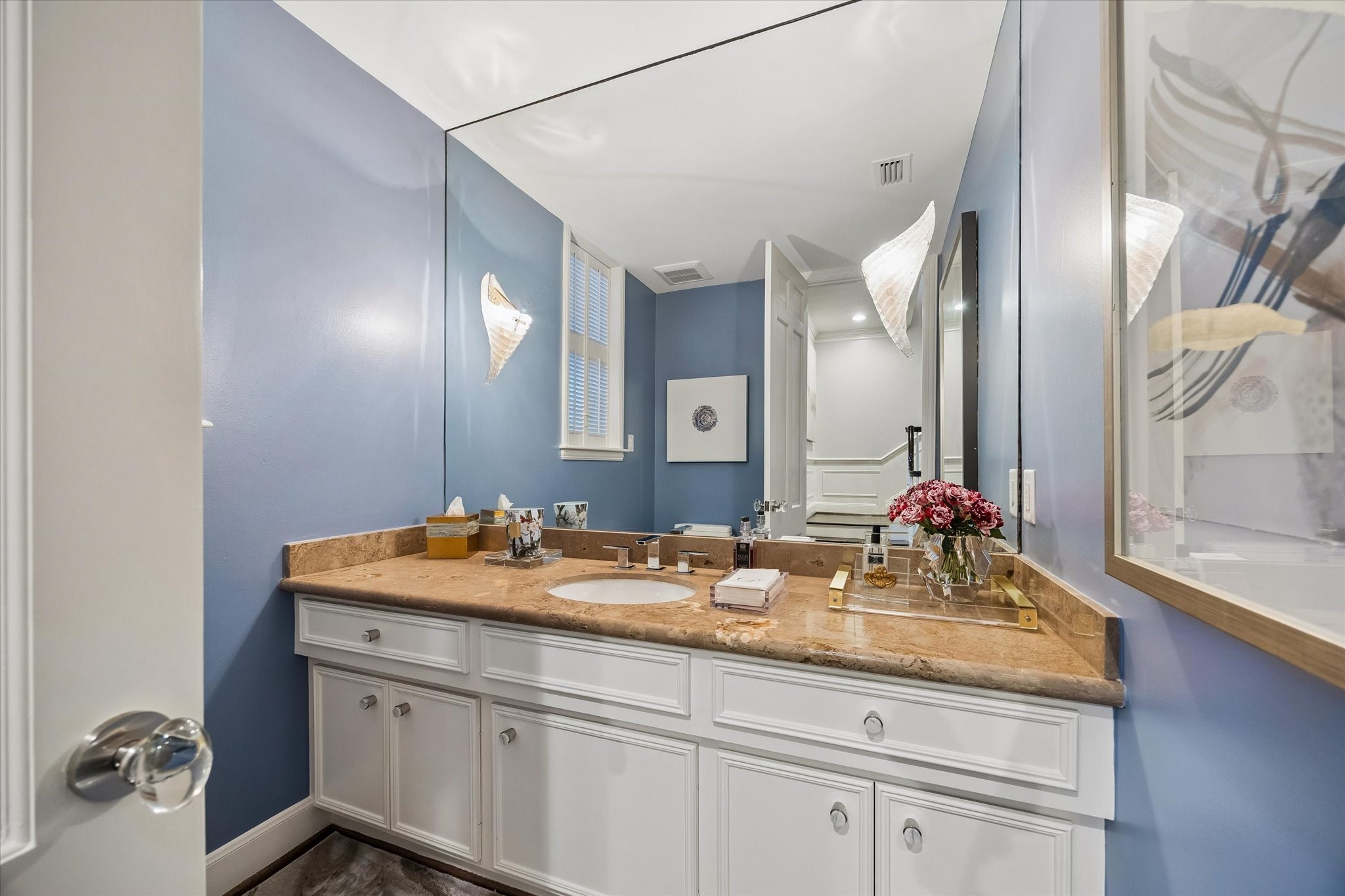 Completing the First Floor is an exquisite Powder Bath with brick floors, a marble counter and a nice amount of storage.