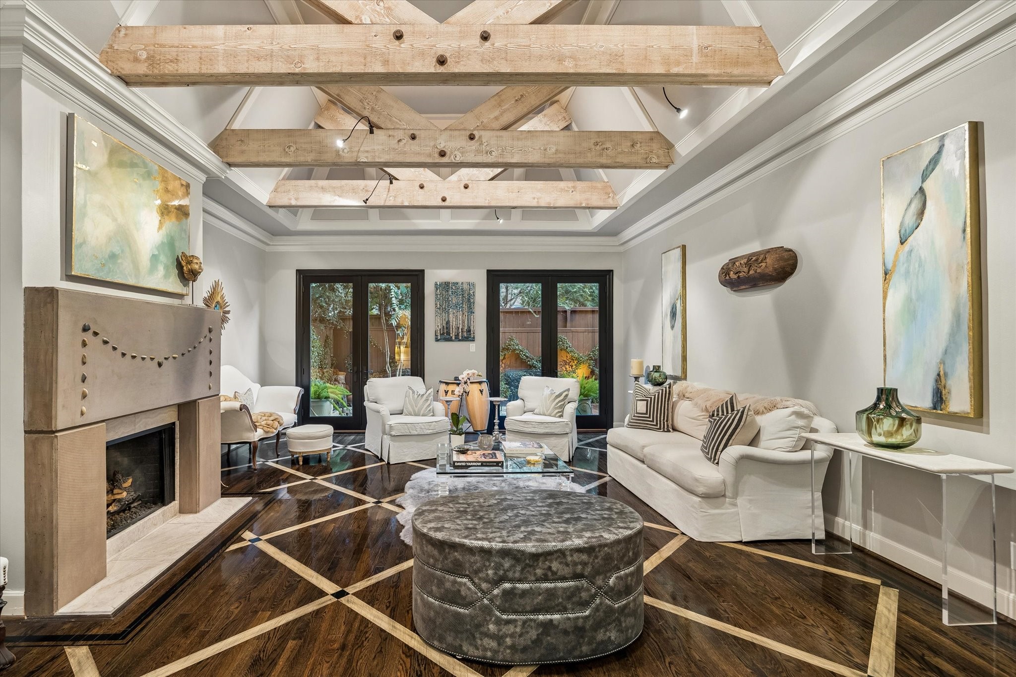 Around the corner from the Entry: Under foot in the commodious Great Room are glossy ebonized patterned hardwood floors; above you reclaimed beams punctuate soaring ceilings.
