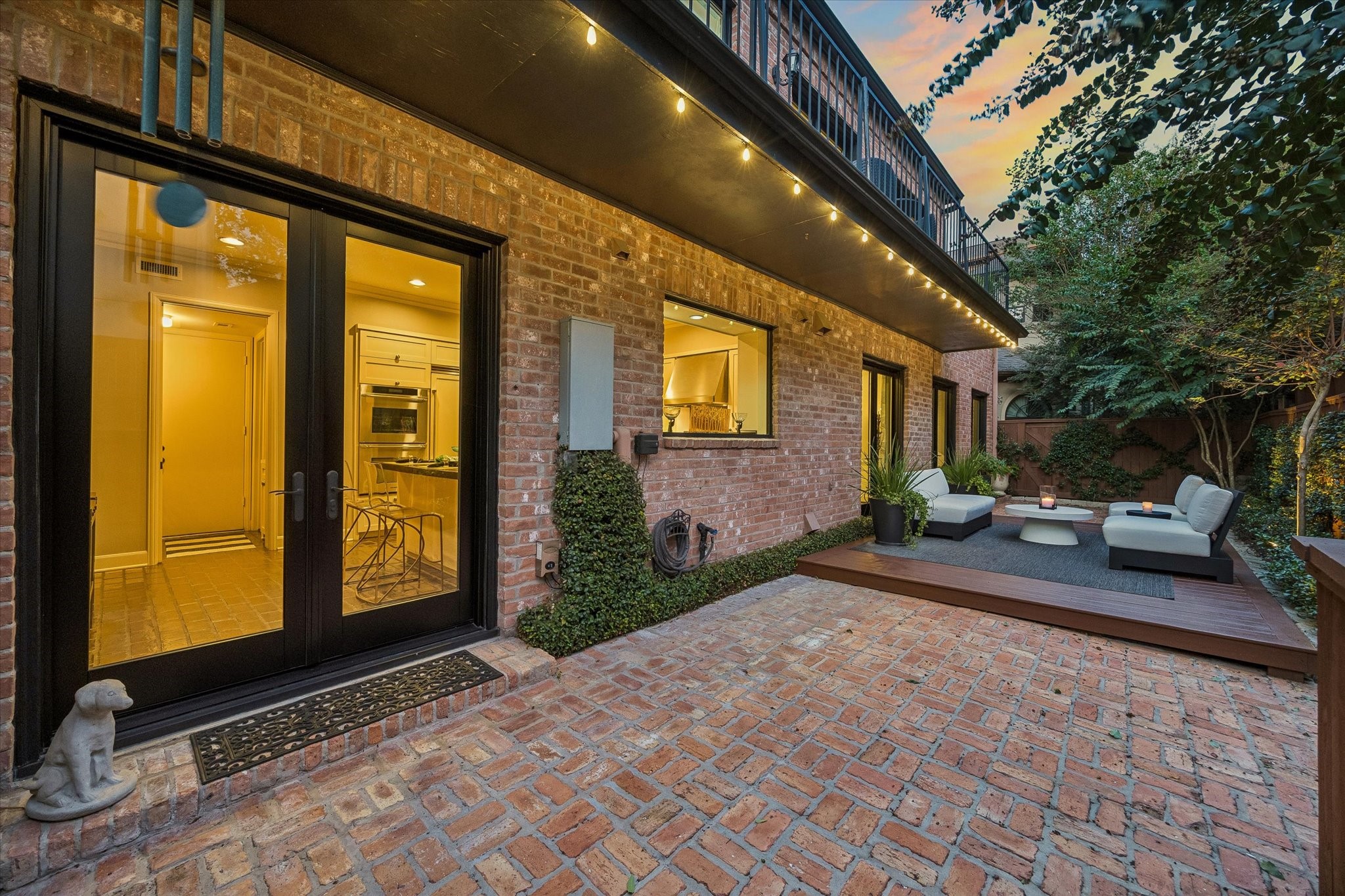 Behind the home is a sweeping, private Garden with two brick patios, a raised deck all surrounded by lush landscaping and a warmly stained privacy fence.