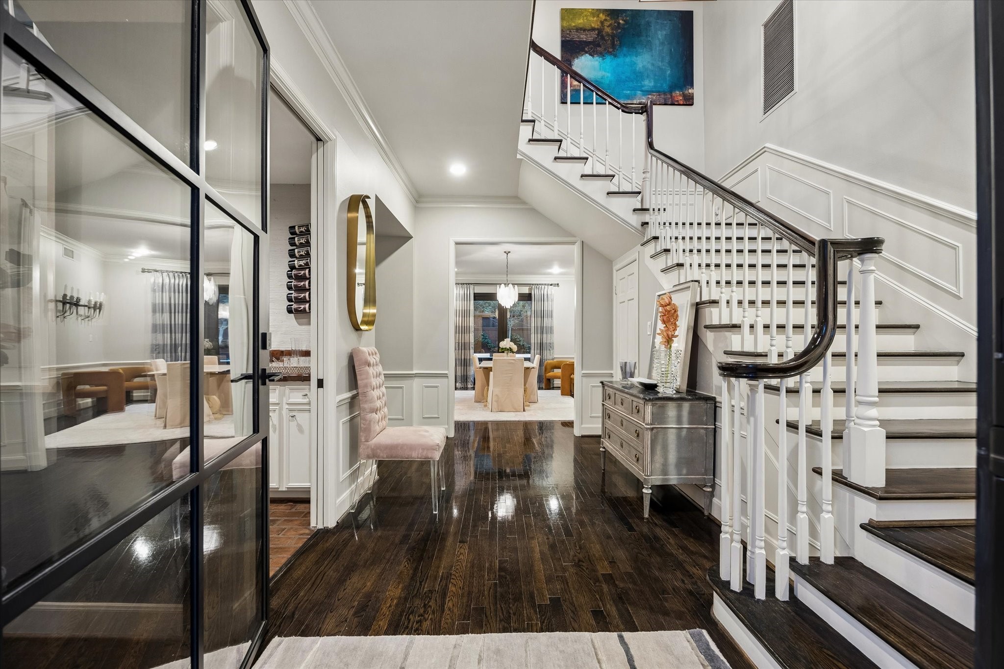 Inside a home that should have and could have graced the pages of Architectural Digest the broad Entry welcomes you. Below your feet are glittery hardwood floors and around you are warm colors and textures including artful millwork.