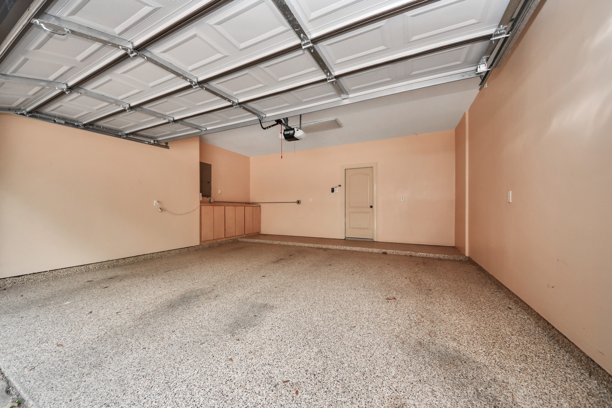 Spacious garage with an EV charger for your electric vehicles; along with cabinets for extra storage.