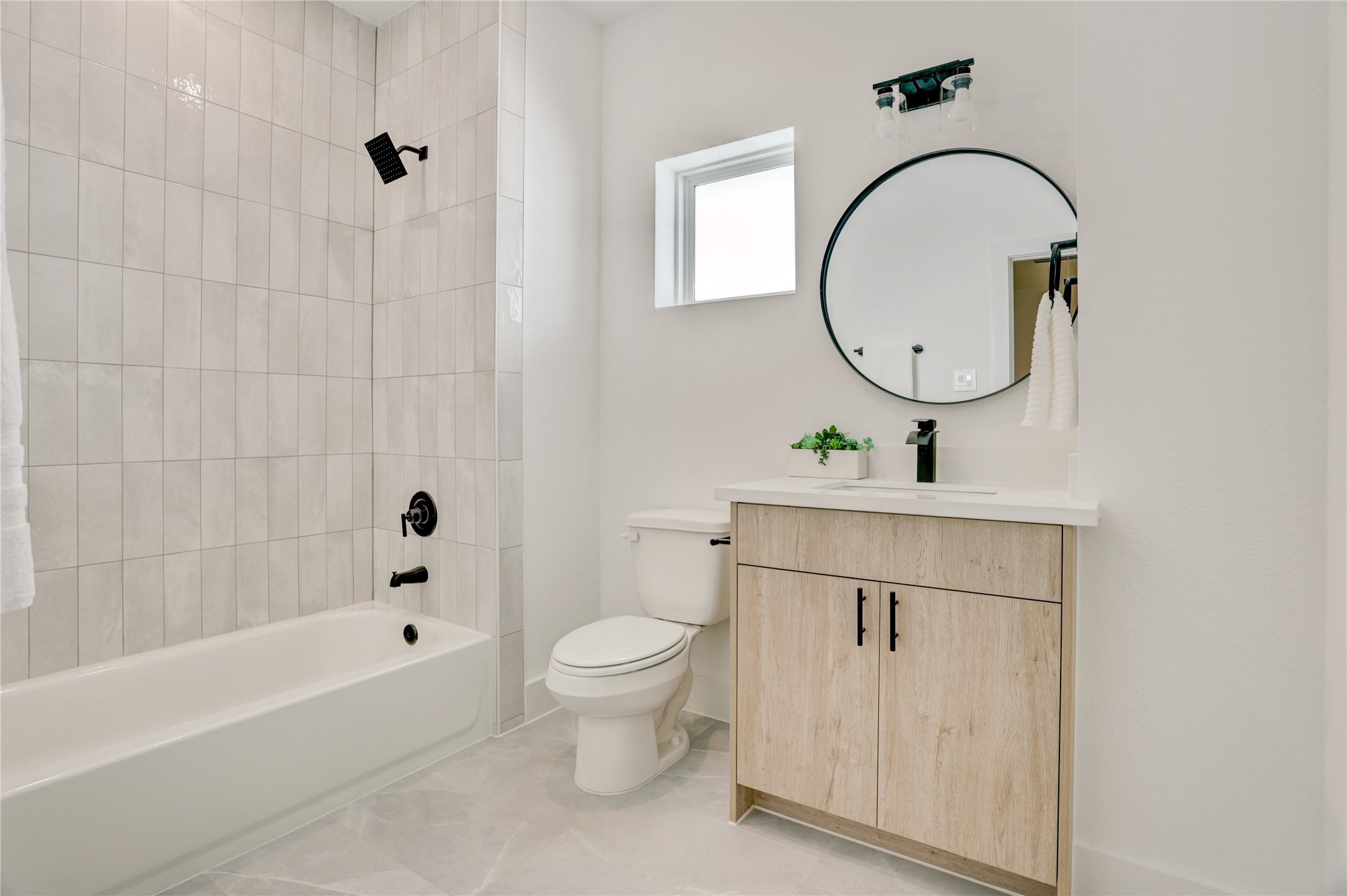 The 2nd full bath has a tub/shower combo with tile surround.