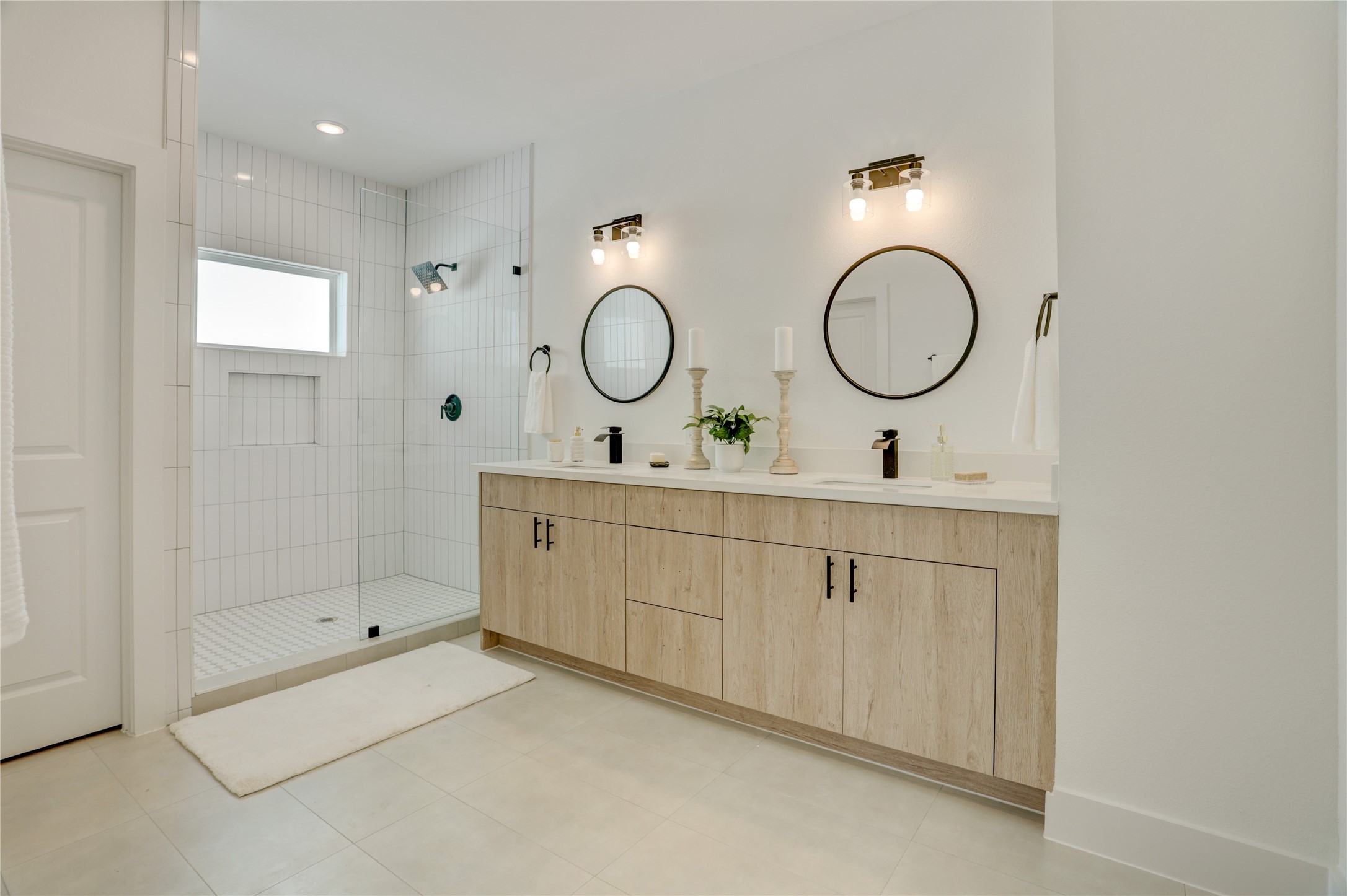 The primary bath has solid wood cabinets, custom lighting, 3cm quartz counters, and custom fixtures. The primary bath has solid wood cabinets, custom lighting, 3cm quartz counters, and custom fixtures.