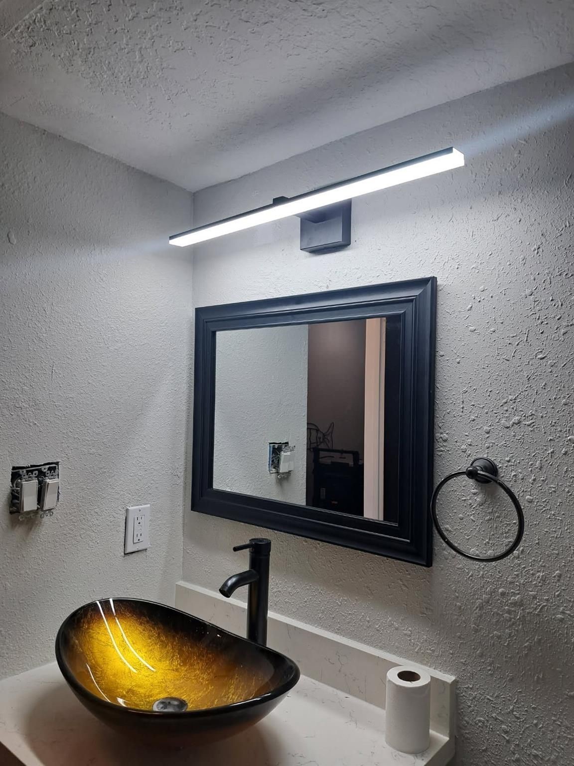 Updated bath with glass bowl sink and new vanity with updated light fixture