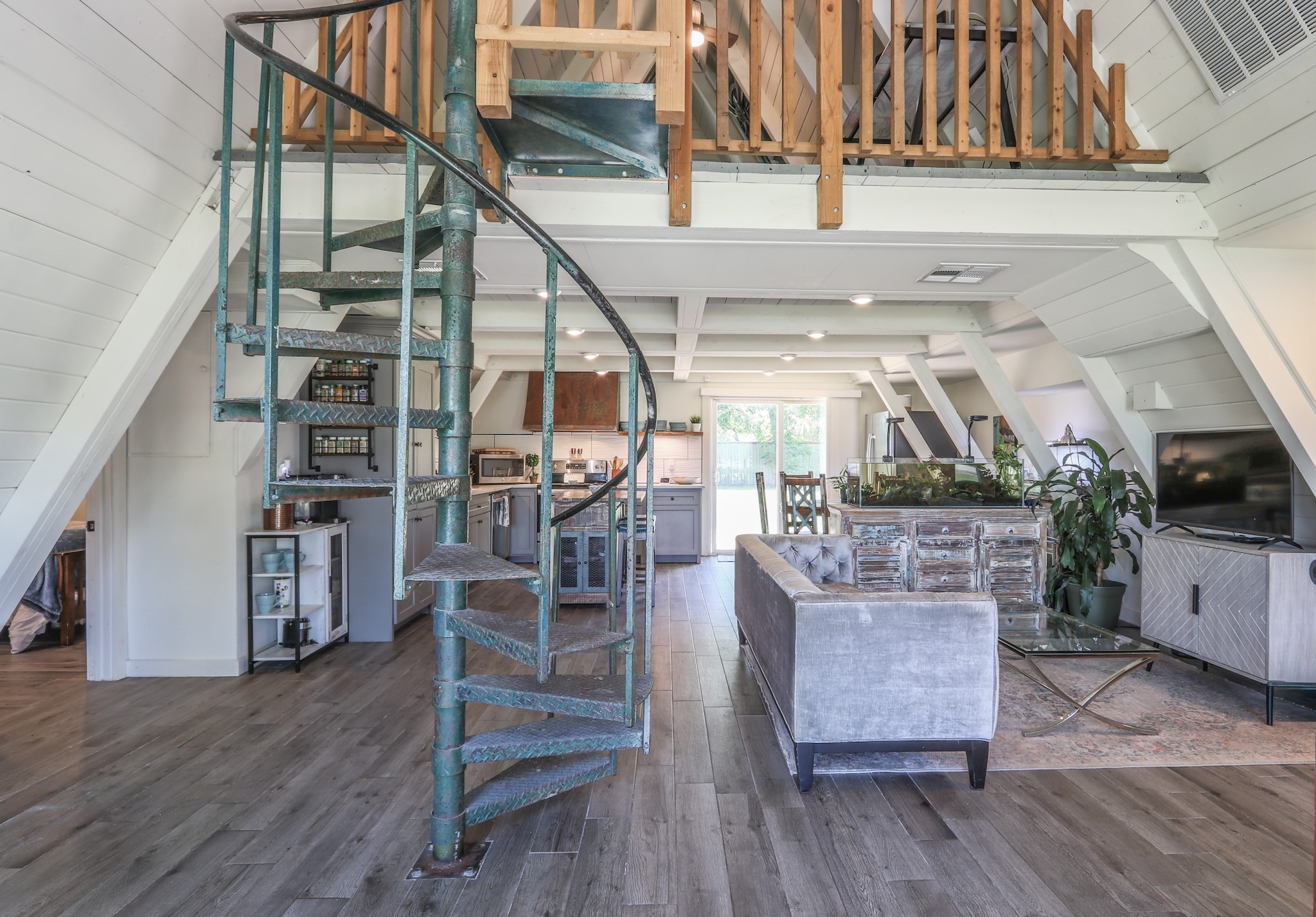 Here is that 70's vibe with a spiral staircase that leads to a sizable loft and bonus room upstairs.   The space up there could be used as an office, gameroom, guest suite with the bonus room off the open loft.