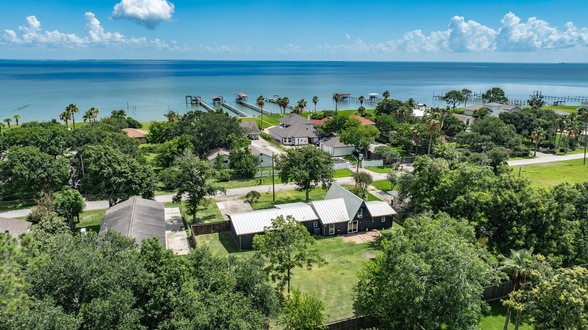 This aeriel shot shows the back of the home and its proximity to the water!   Easy to walk around the corner and drop a line in the water or just enjoy the view.