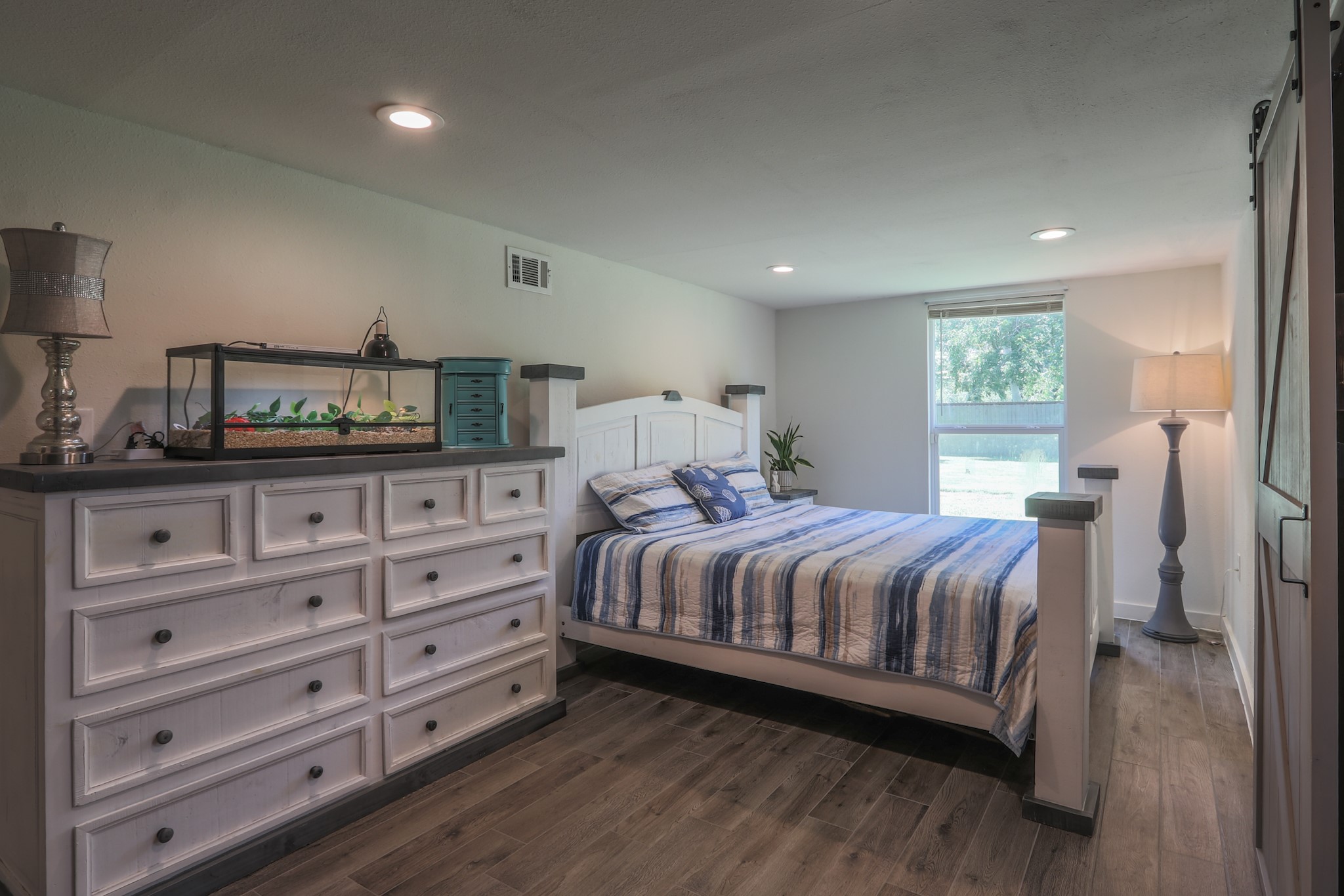Second Bedroom is also a nice size with recessed lighting and its own private bath behind the decorative sliding barn door.