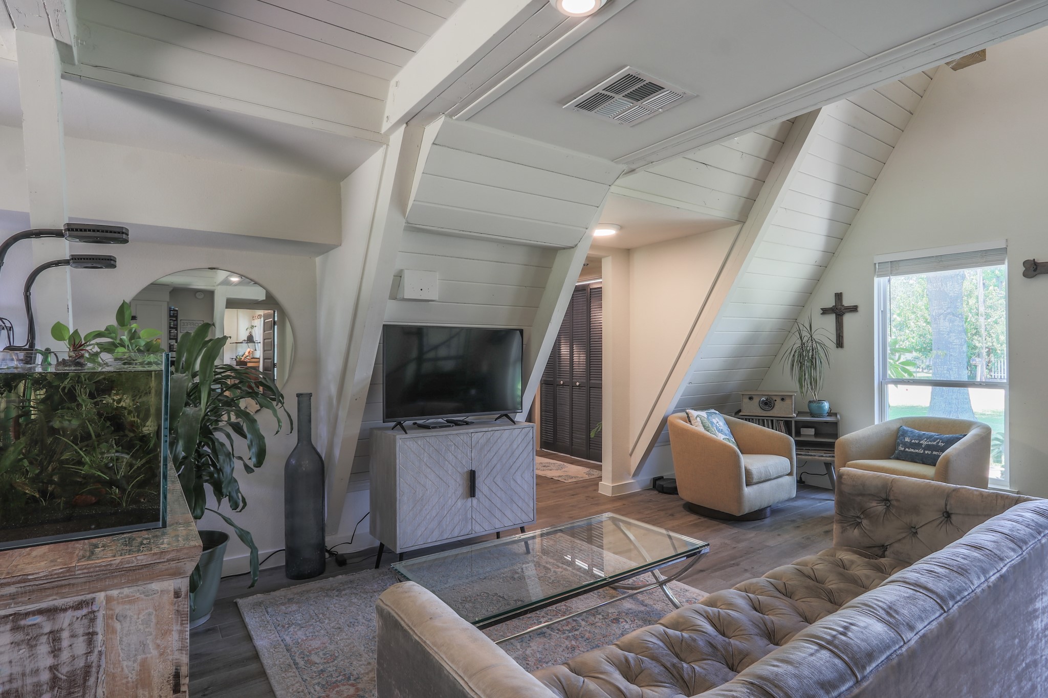Looking at the living room - Nice windows, great natural light, the large piece with the aquarium on it separates the living space from the breakfast area... without that in the space it is very open and spacious.  Doors in hallway is the laundry room.