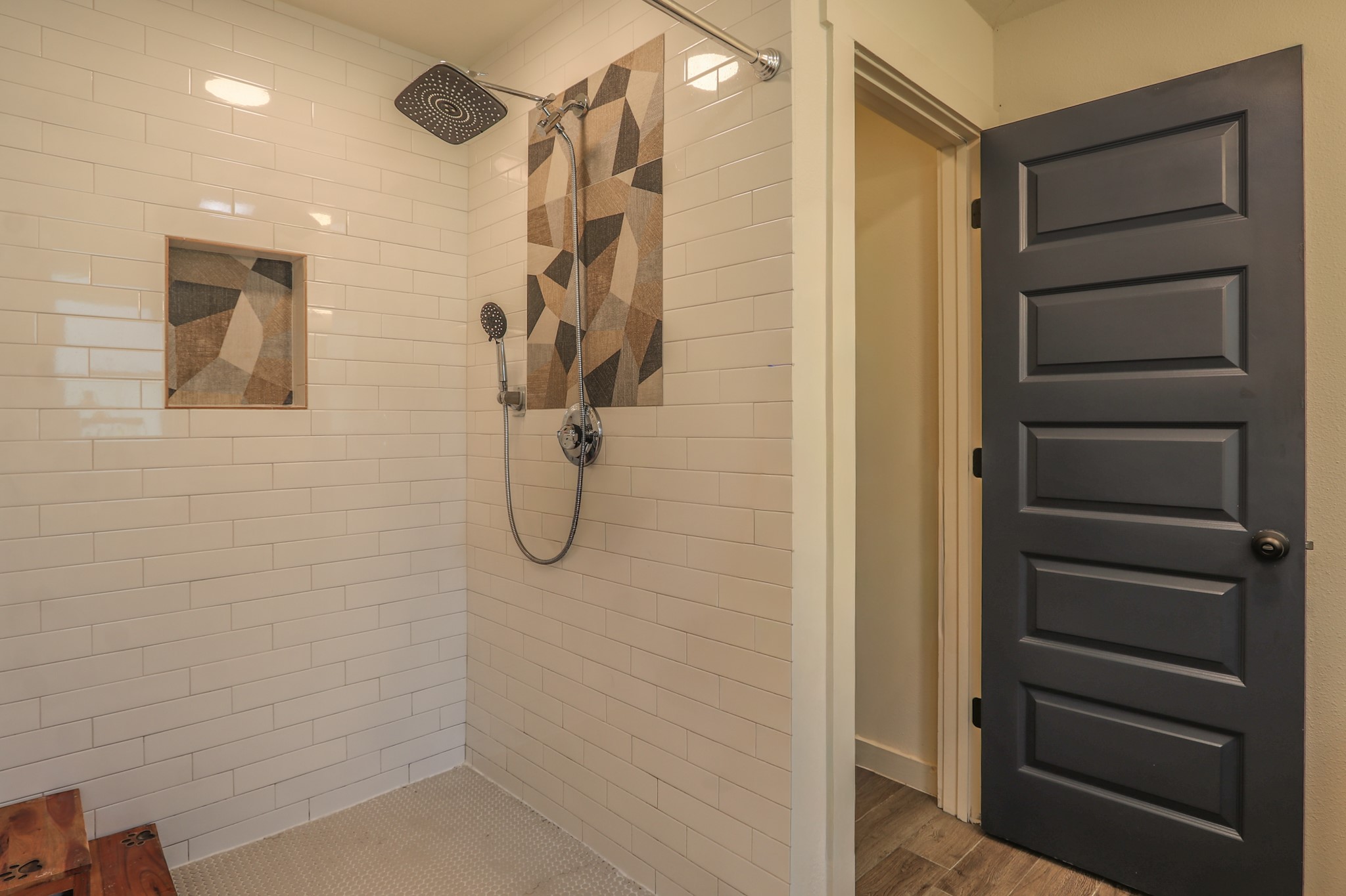 Custom tile shower features nice hardware and really cool accent tiles.  Very big shower and easy access... Private Water Closet to the right of the shower.