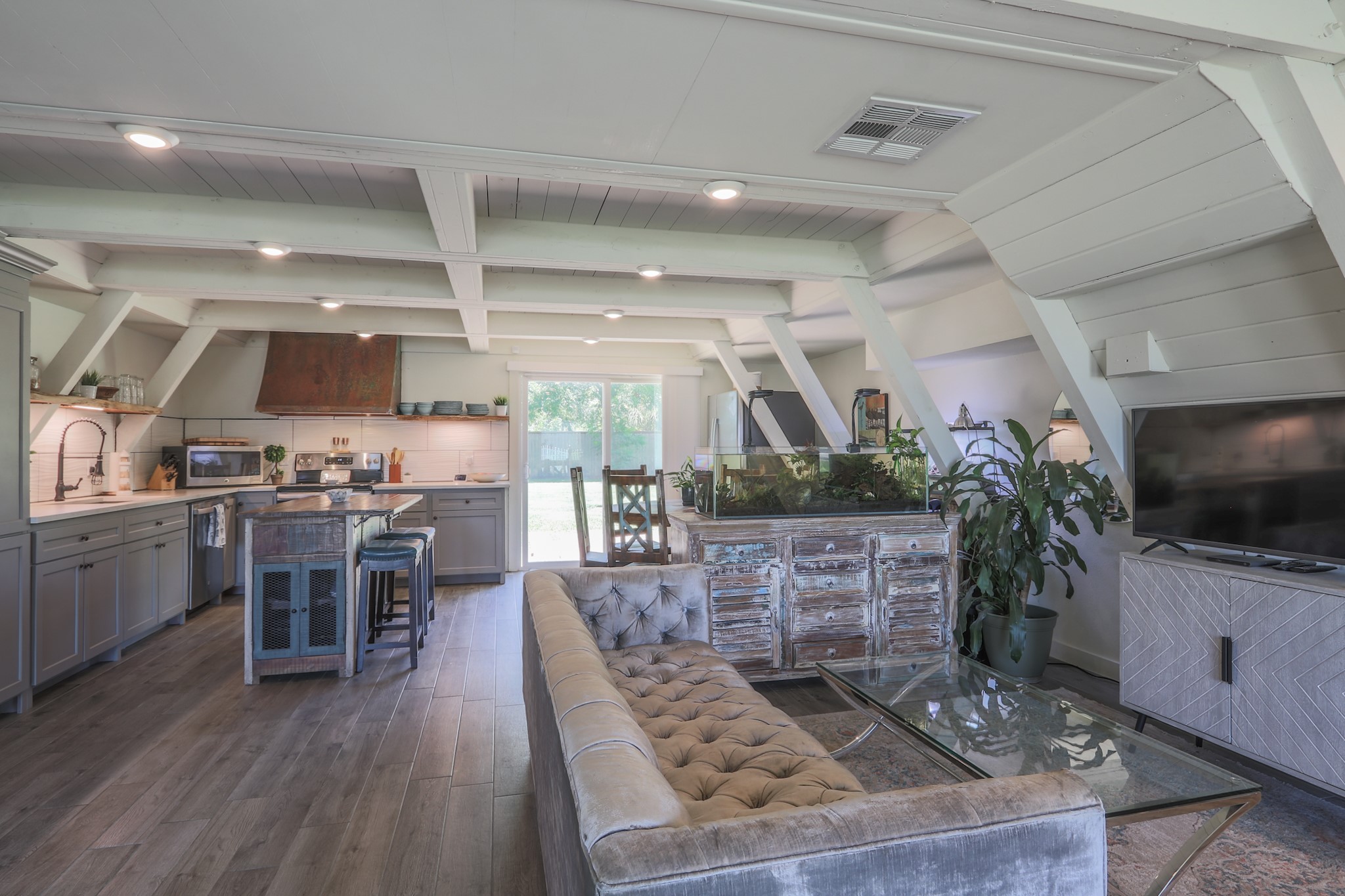 As you enter- the living room, dining space and kitchen are all open and connected... great design to entertain family and/or friends.  Take note of the Shiplap and Beam construction overhead, painted out a nice soft white with lots of recessed lighting throughout the home.