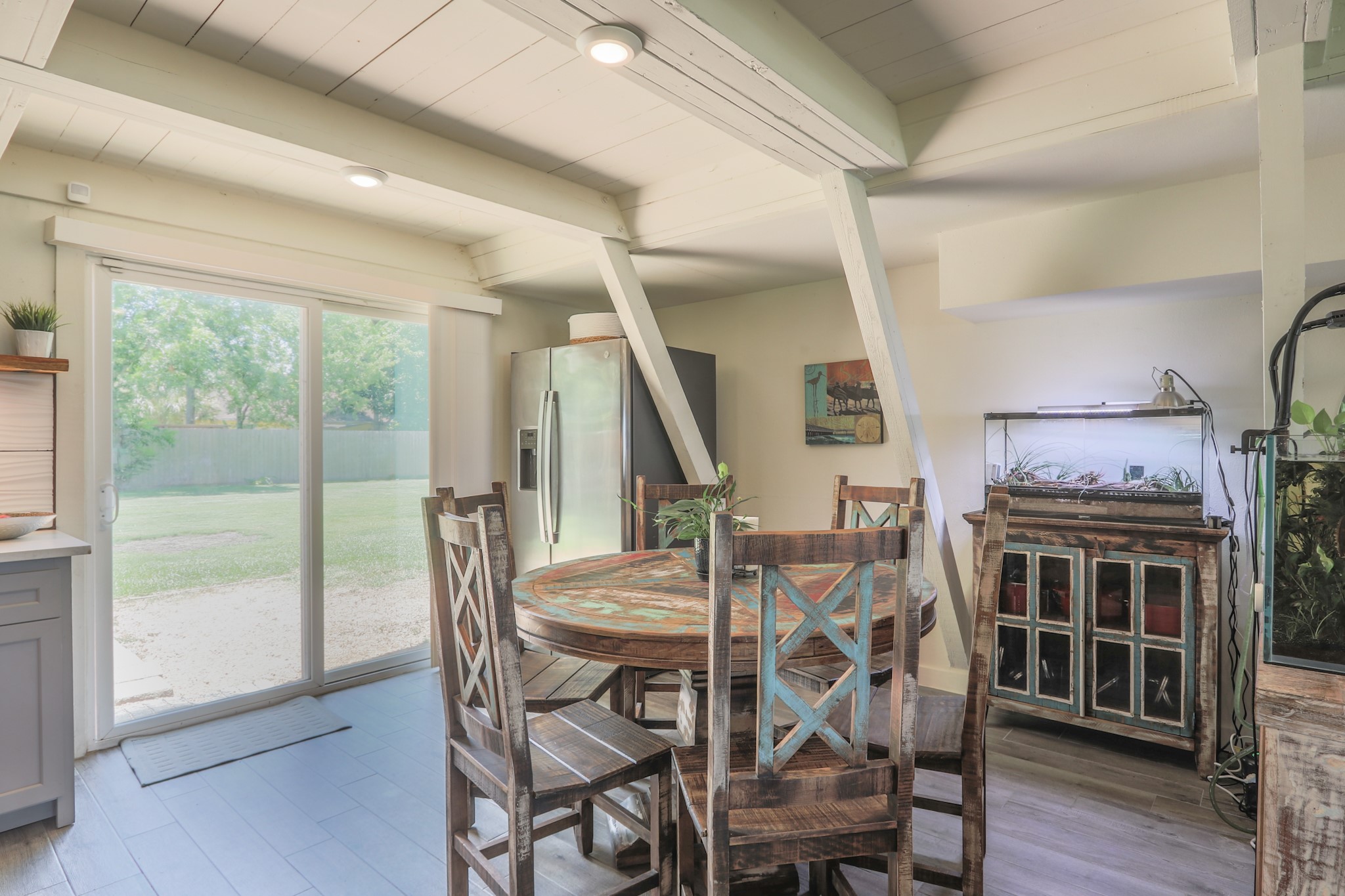 Natural light floods in for that morning coffee overlooking the huge back yard.    Take note of the small buffet with the aquarium on it - that will be left for the new owners with the dining set and island that match it.