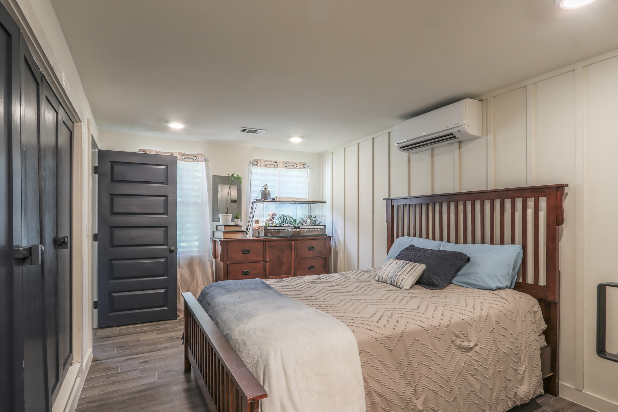 Another view shows the navy closet doors and 5 panel door entering the room.