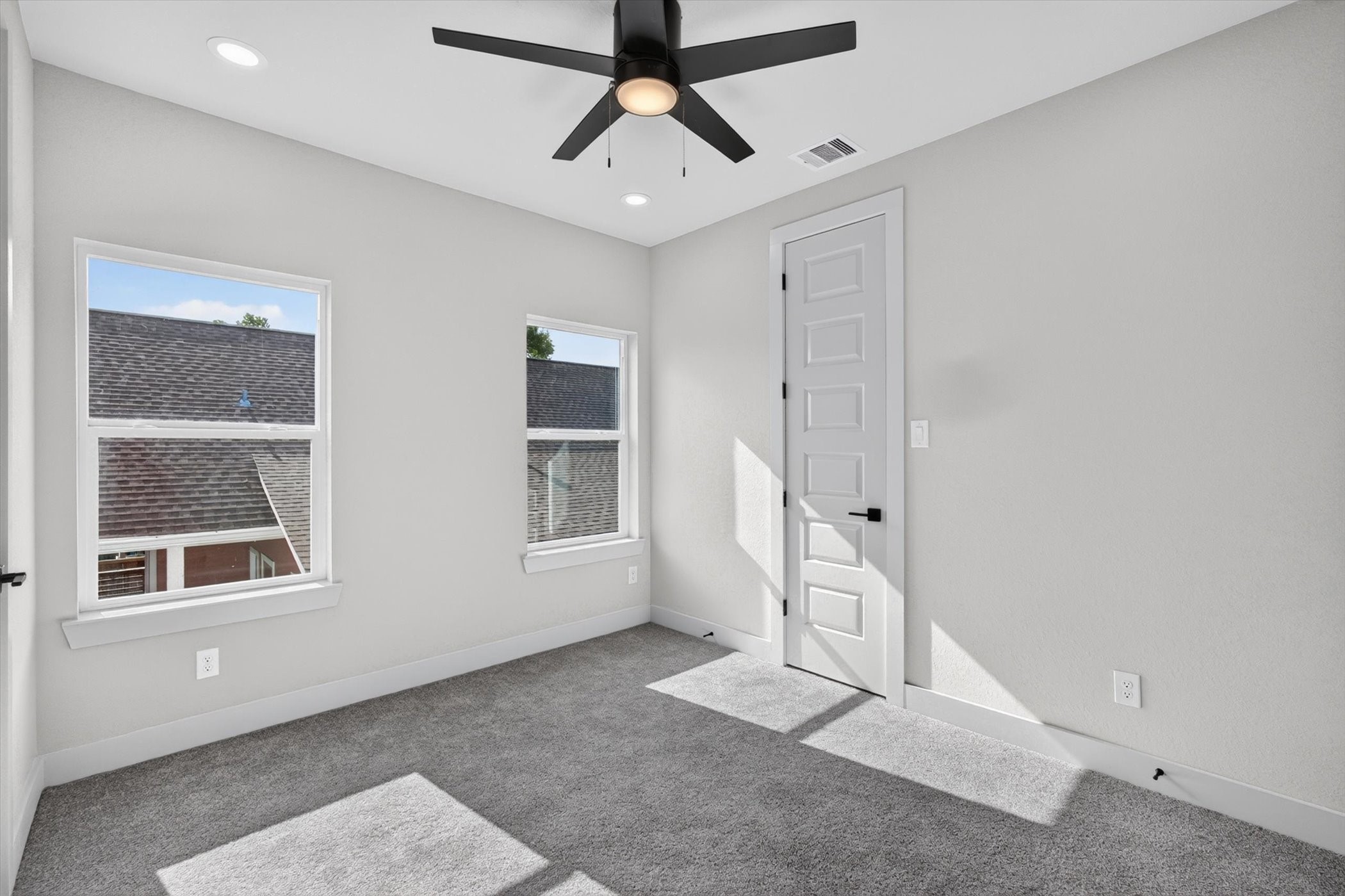 This photo features a modern, open-concept living and dining area with large windows, contemporary furnishings, and wood flooring. The space is bright and inviting, with neutral tones and stylish decor, making it ideal for entertaining or relaxing.