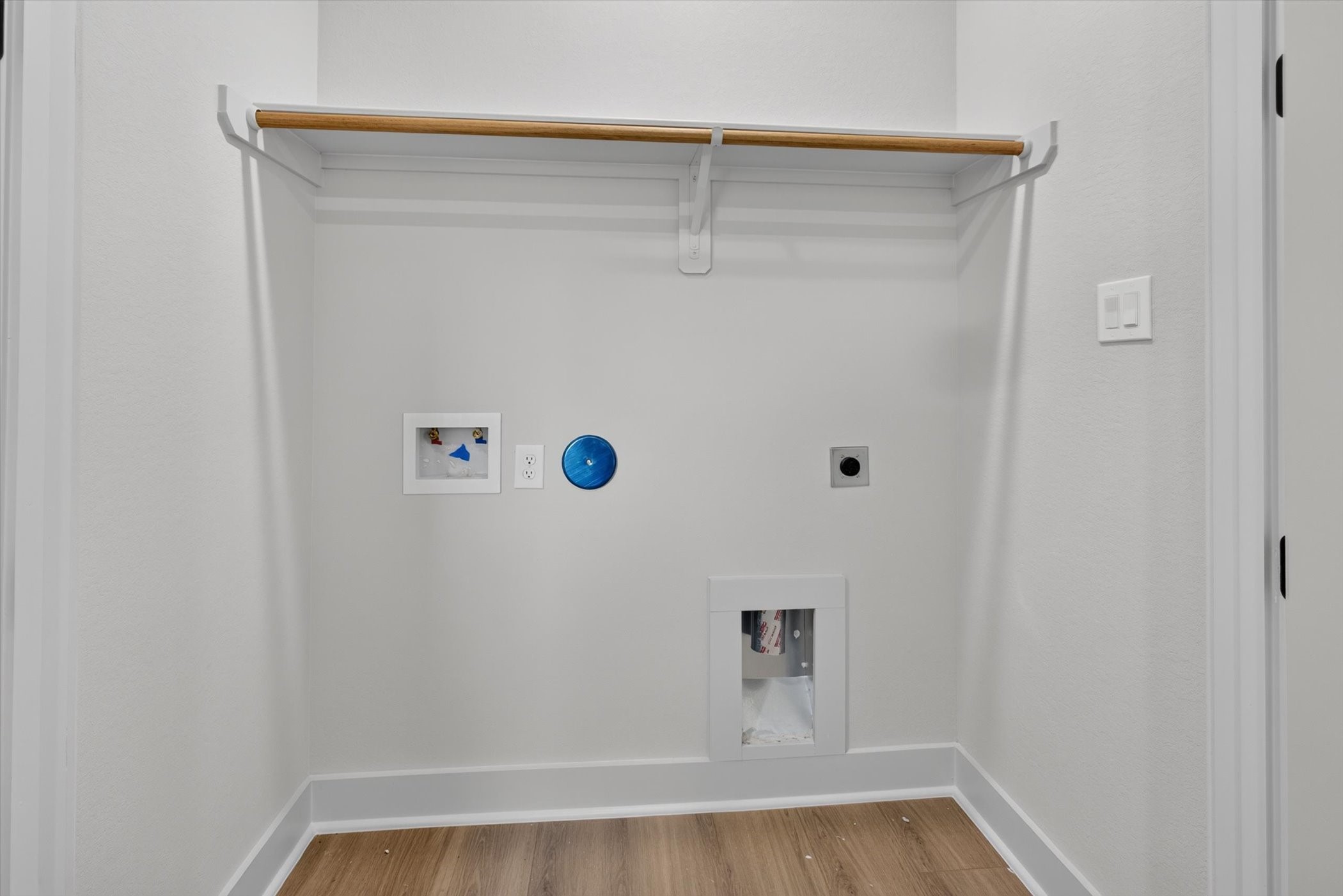 Full sized laundry room with built in shelving.