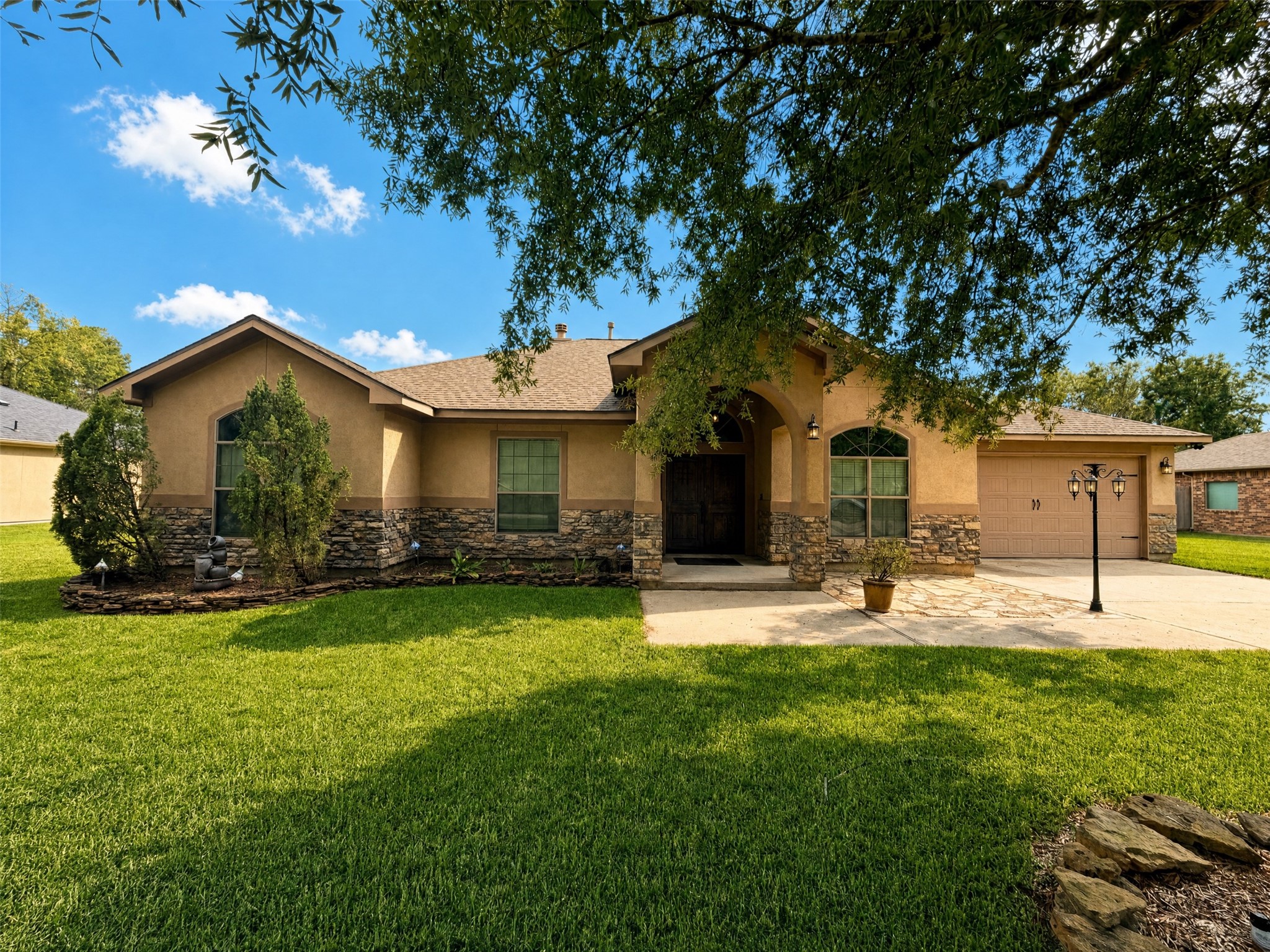 Charming single-story home with a stone-accented exterior, inviting arched entryway, and manicured lawn, offering great curb appeal in a serene neighborhood. Charming single-story home with a stone-accented exterior, inviting arched entryway, and manicured lawn, offering great curb appeal in a serene neighborhood.