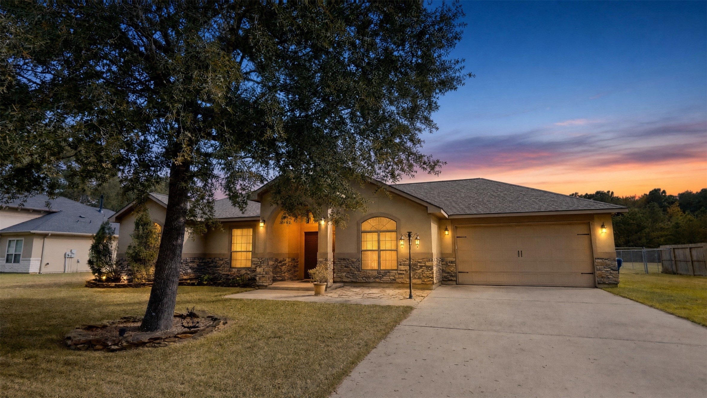 Charming single-story home with stone accents, nestled under a mature tree, featuring a welcoming front porch and spacious driveway. Charming single-story home with stone accents, nestled under a mature tree, featuring a welcoming front porch and spacious driveway.